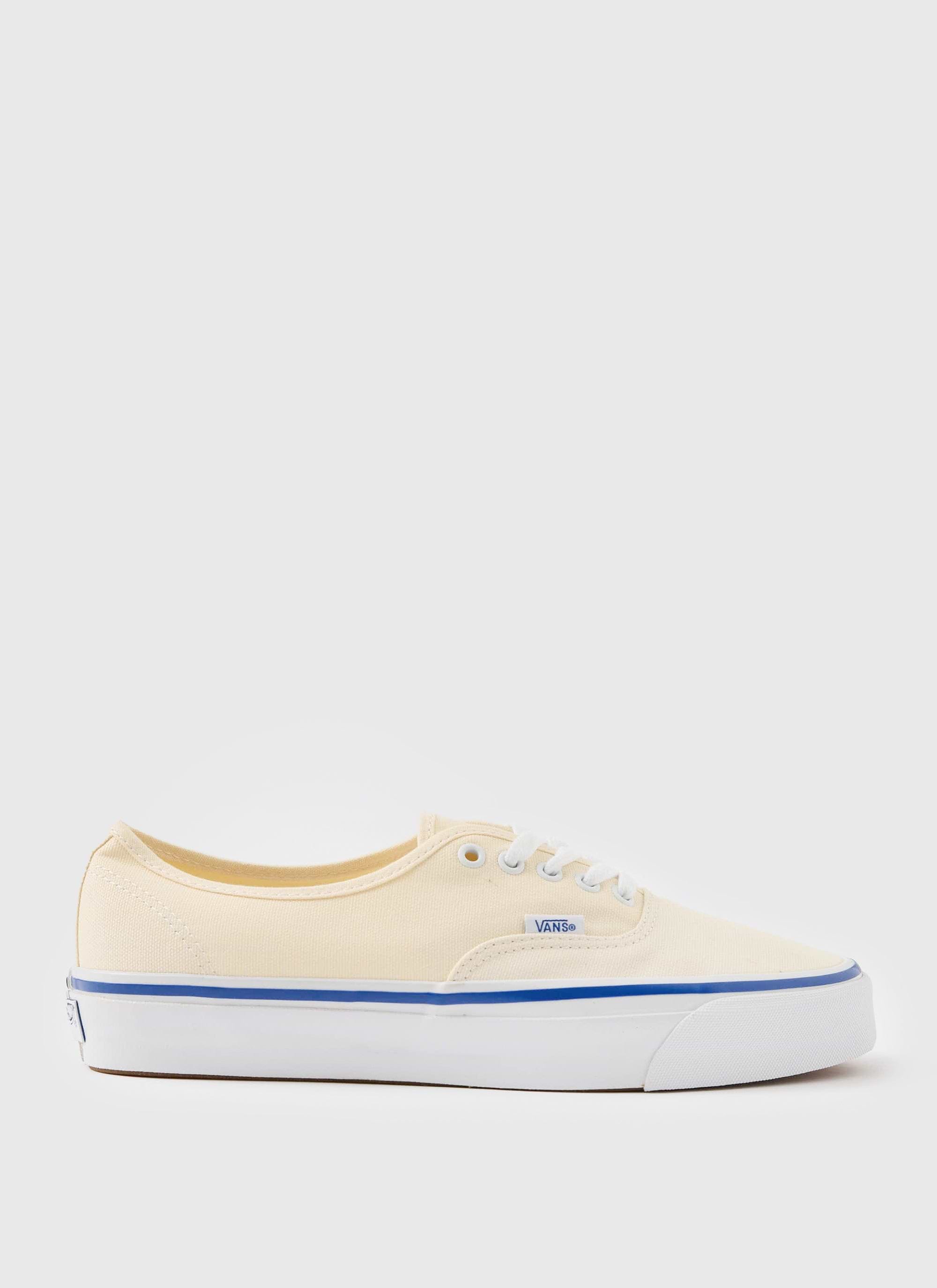 A side profile of the off-white Vans Premium Authentic 44 shoe against a plain studio background, available at Percival.