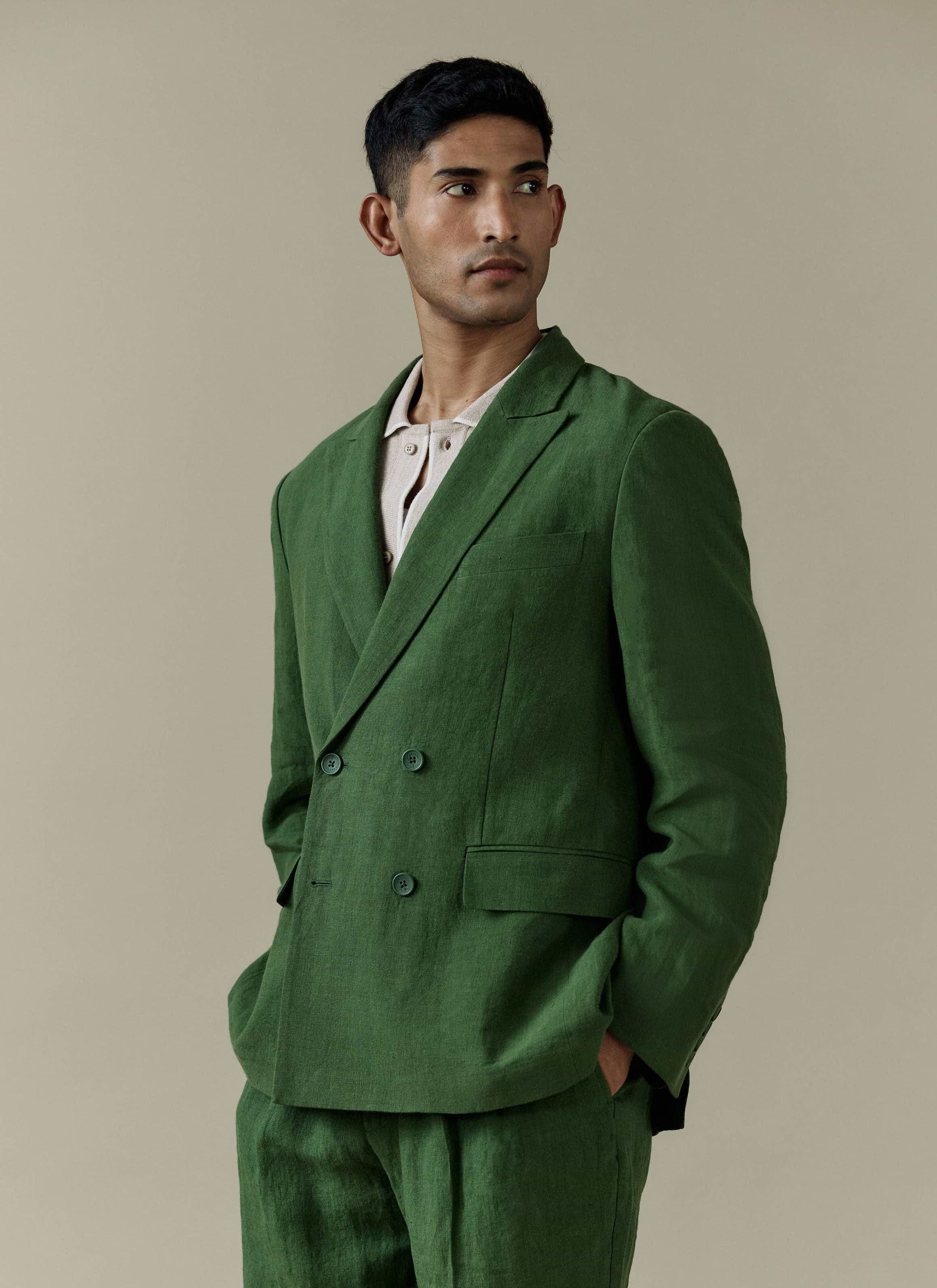 Forest green linen Percival Clifton Double Breasted Blazer and matching trousers, styled with a light cream polo shirt.