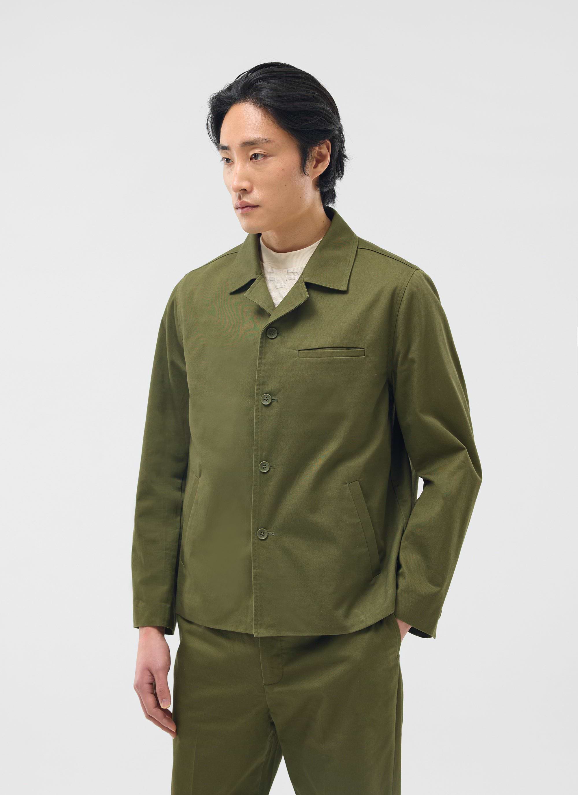 A model wears the Percival Casual Workwear Jacket in khaki cotton, part of a matching set, in a studio.