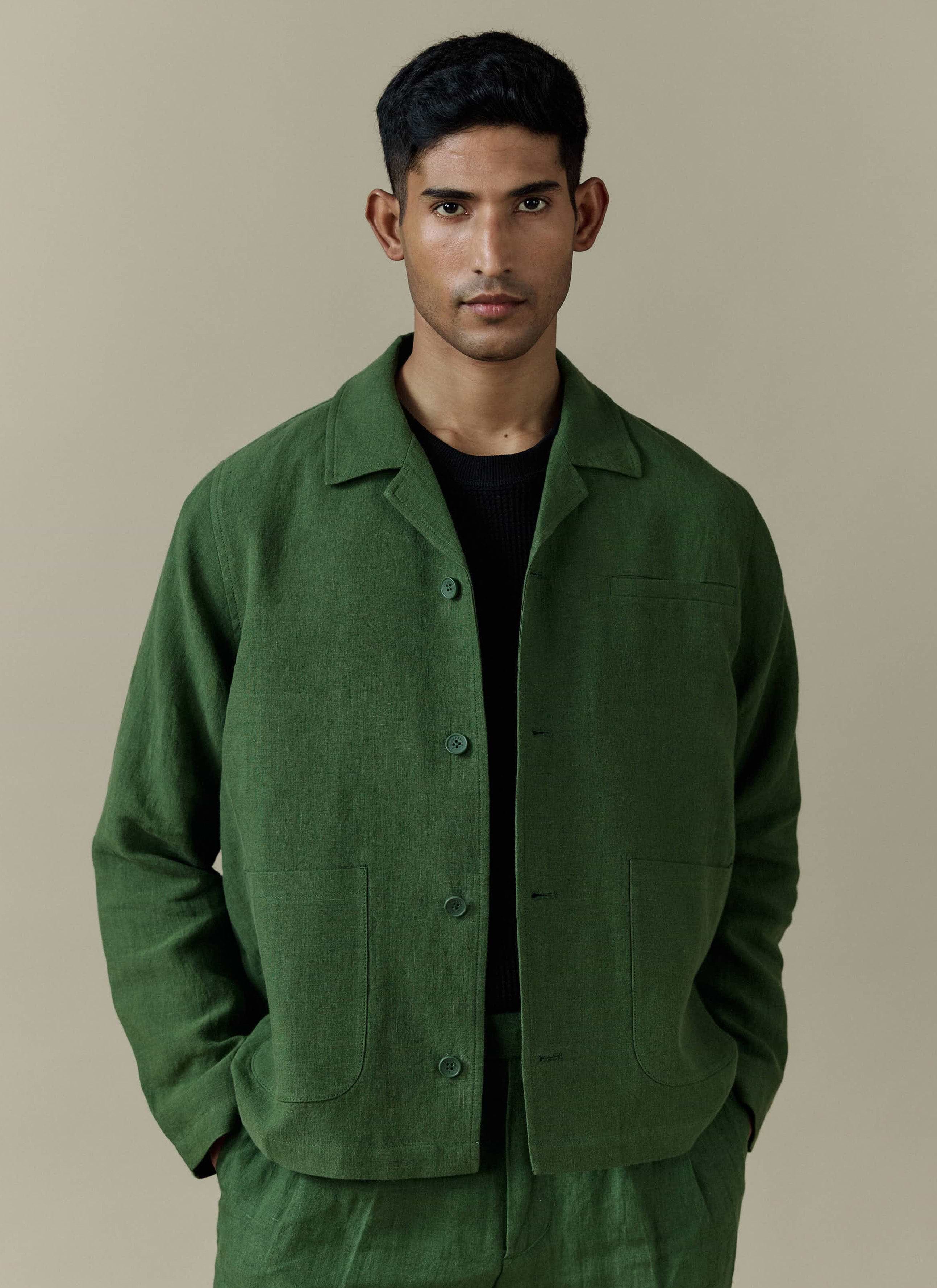A model wears the Percival Linen Overshirt in Forest, styled with matching trousers and a black t-shirt.