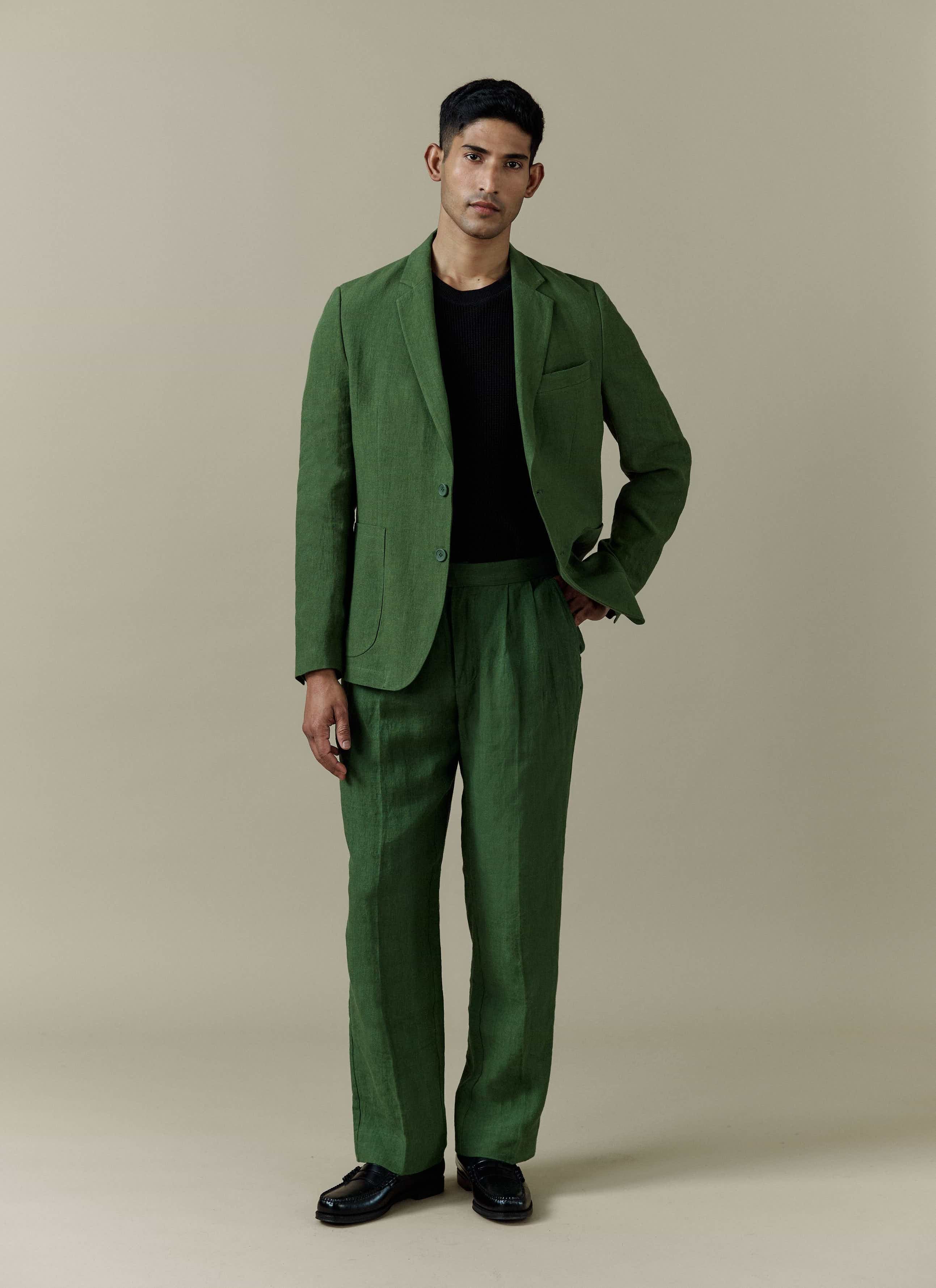 Forest green Percival tailored linen blazer and matching trousers worn by a model in a full-length studio shot.