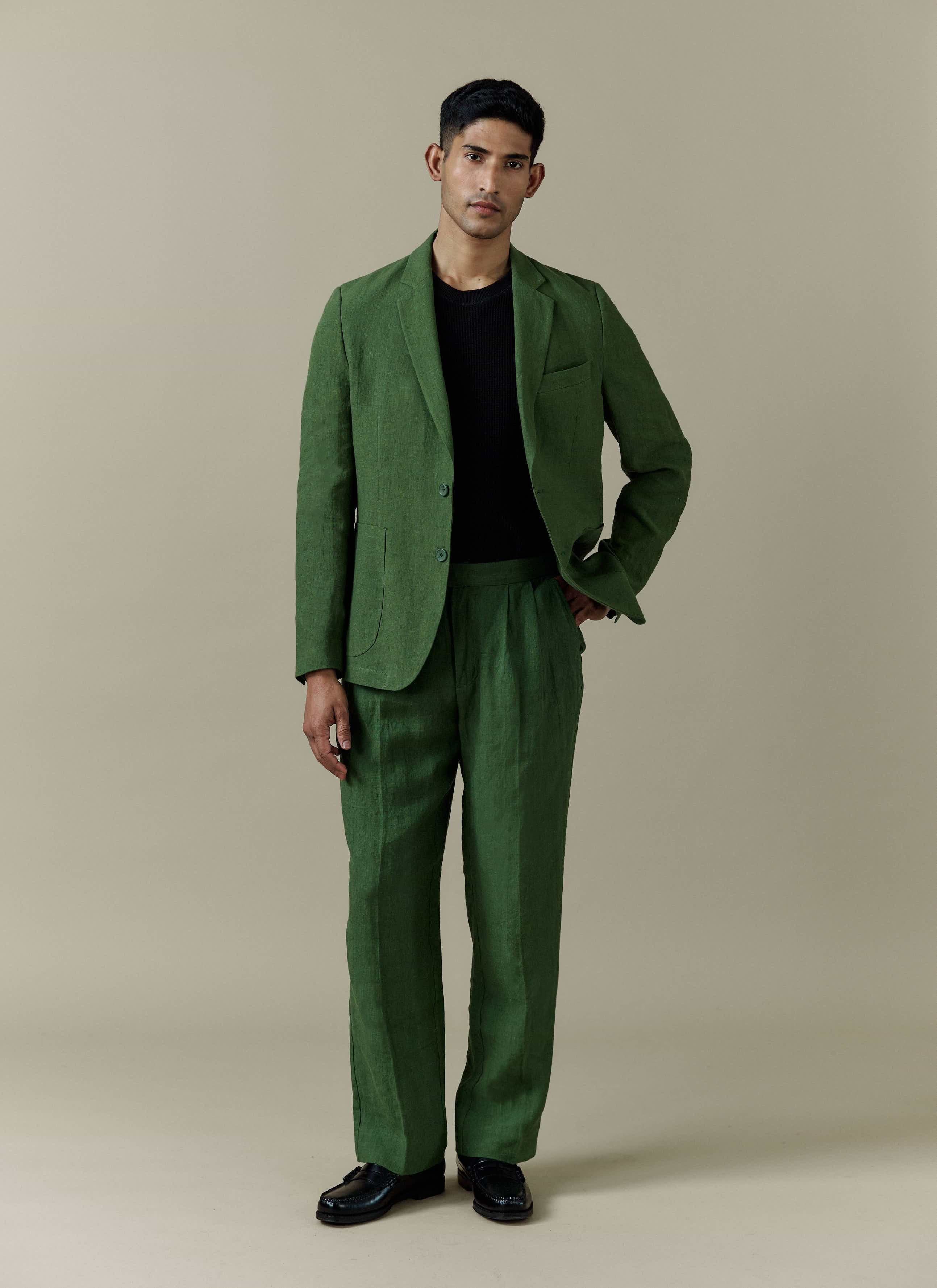 Forest green Percival tailored linen blazer and matching trousers worn by a model in a full-length studio shot.