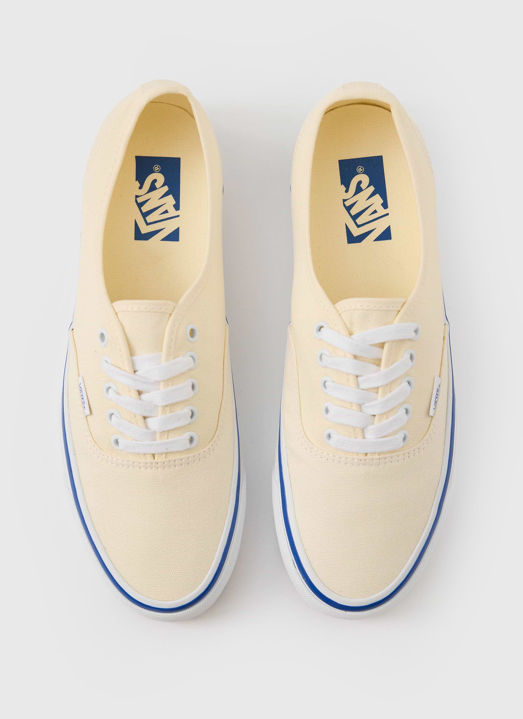 A top-down studio shot of the off-white canvas Vans Premium Authentic 44 shoes, available at Percival.