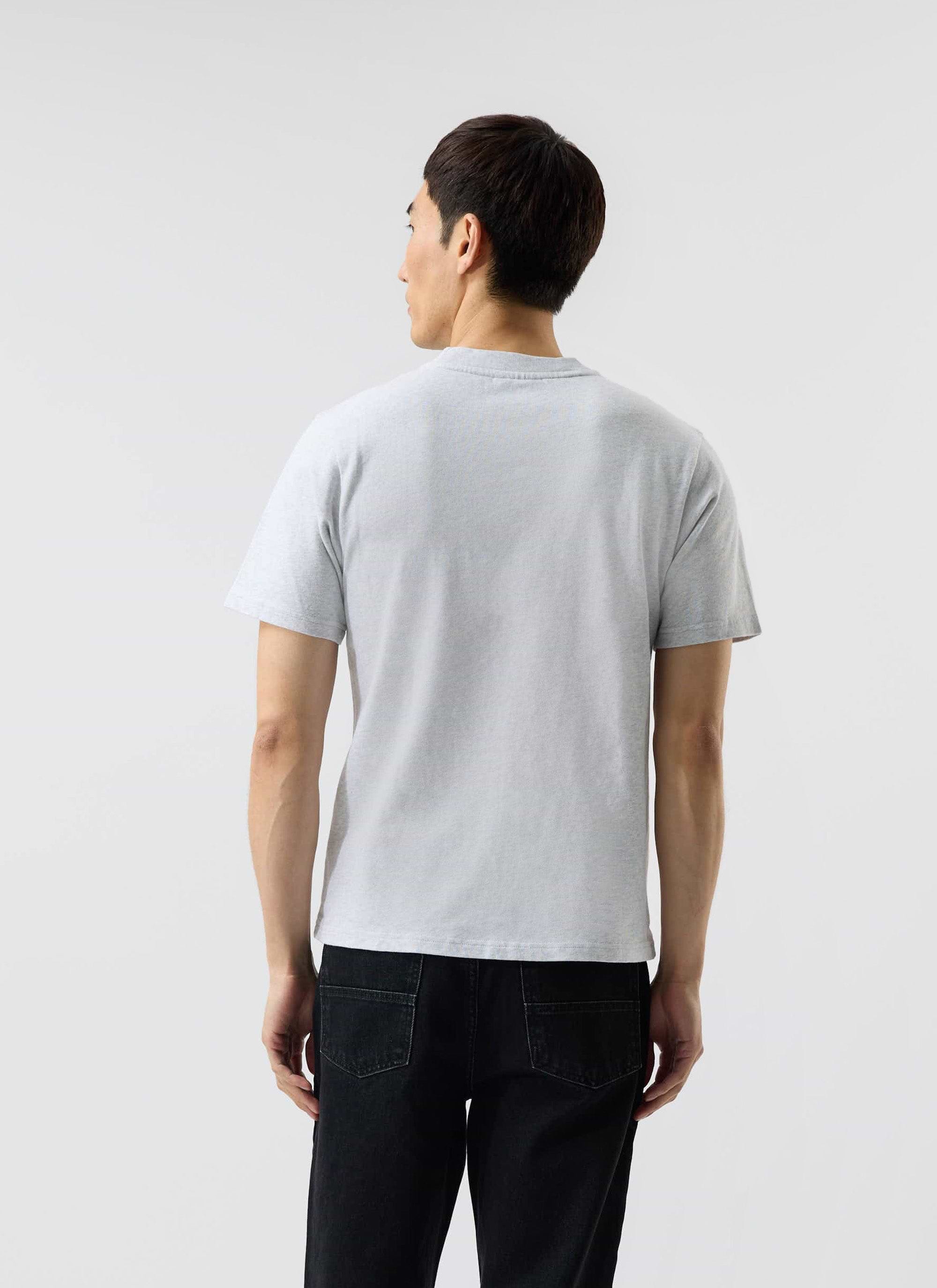 Back view of a model wearing the Percival Cropped Regular Fit T-Shirt in grey organic cotton against a white background.