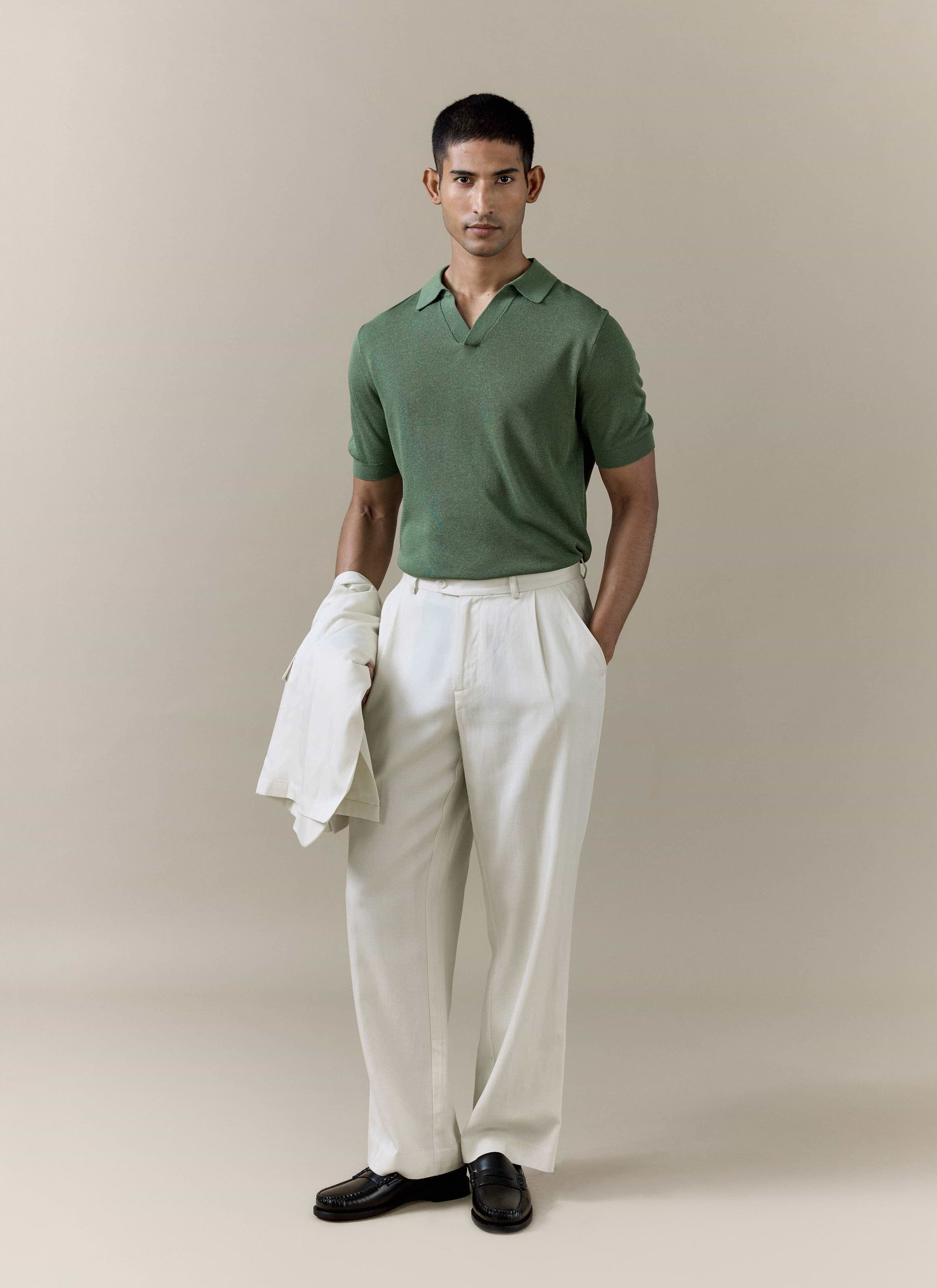 Percival Laurence Knitted Polo in forest green linen blend, styled with cream pleated trousers and loafers.