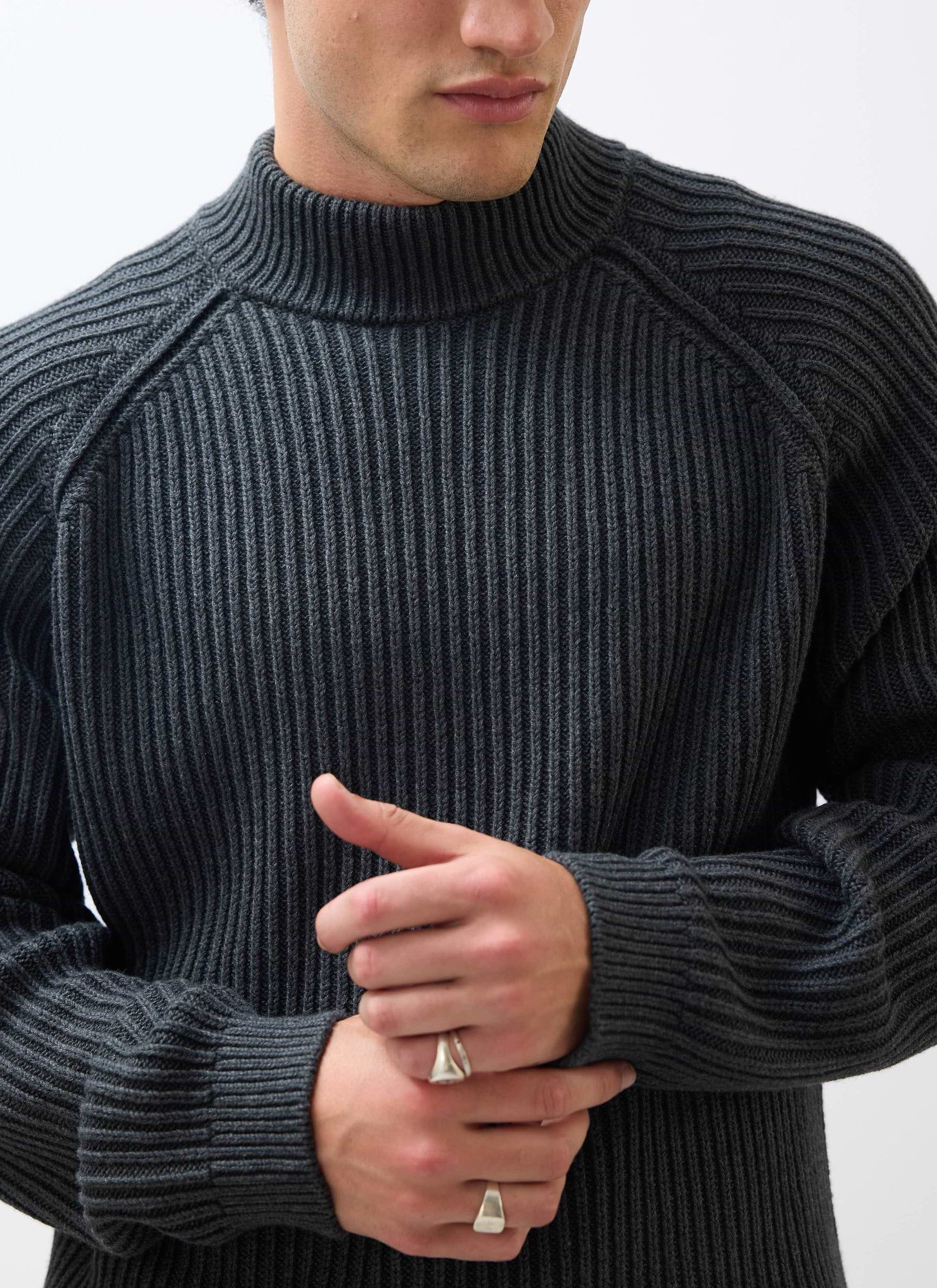 Close up of a model wearing the Percival Library Turtle Neck in charcoal, highlighting the ribbed knit detail.