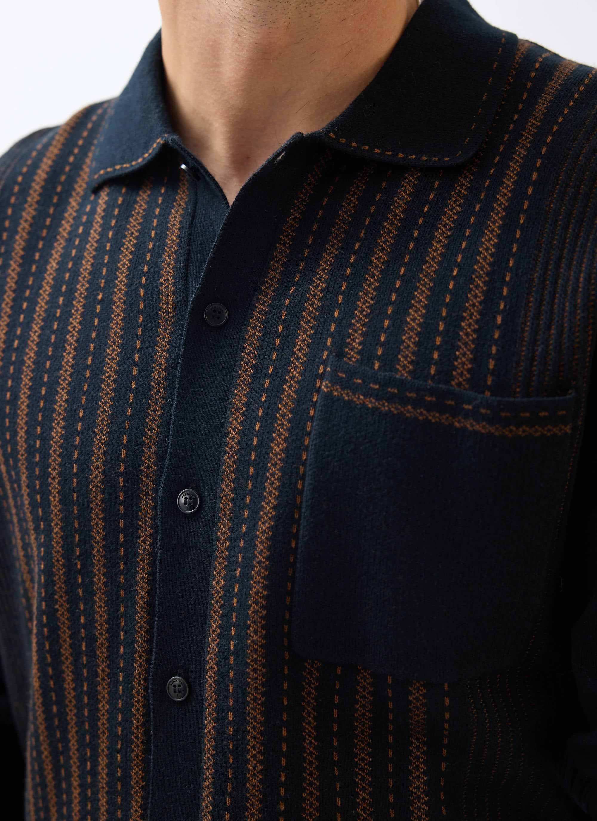 Close up of the Percival Appendix Long Sleeve Knitted Shirt, showing the black and brown jacquard knit, collar, and pocket.