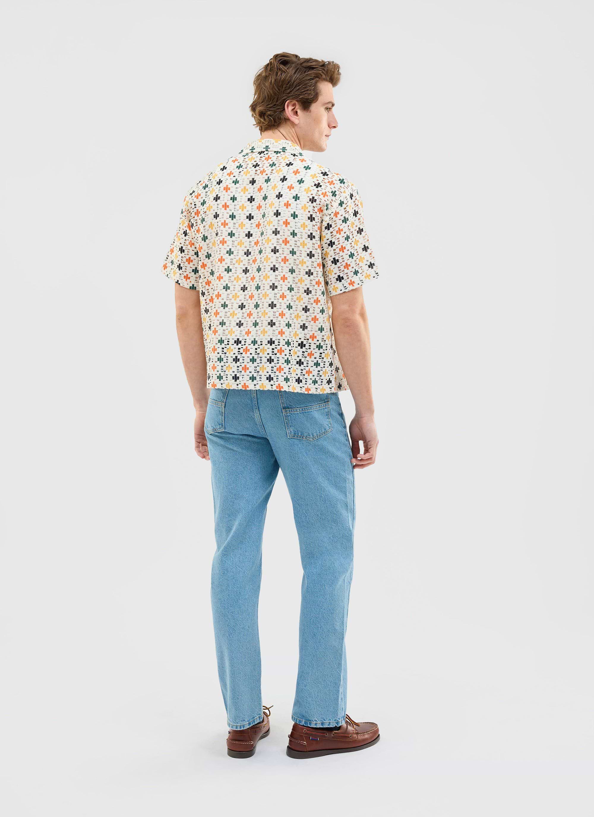 Back view of a model wearing the Percival Bailing Crochet Cuban Shirt in multi, paired with light wash jeans and boat shoes.