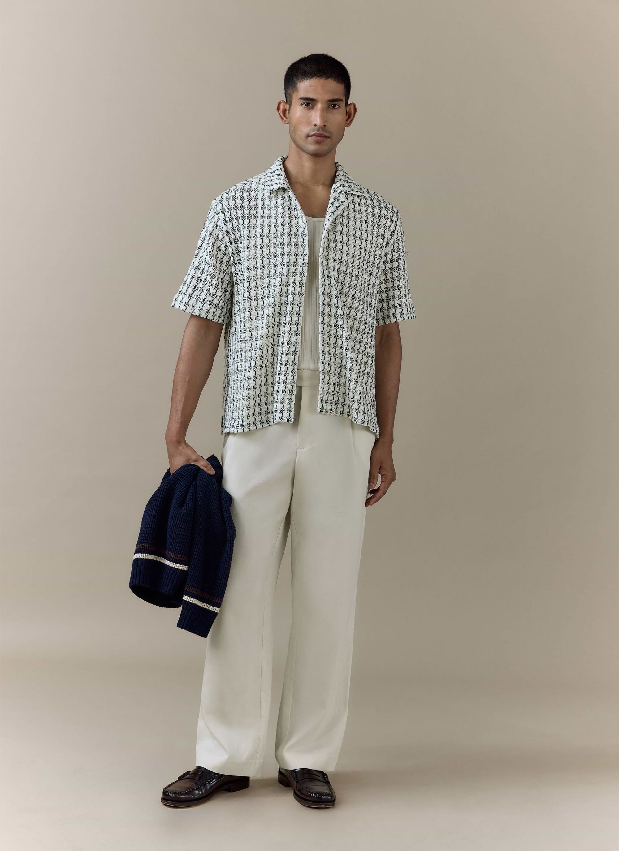 Percival green Freddie Crochet Boxy Shirt in a textured knit, styled on a model with cream trousers and a navy jumper.