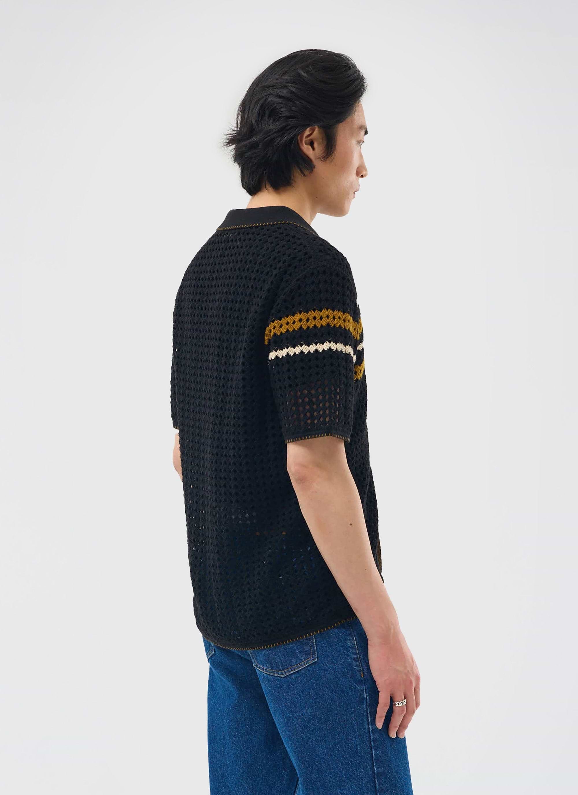 A model wears the black Percival Pesaro Knitted Shirt, showing the relaxed fit and striped sleeve detail from the back.