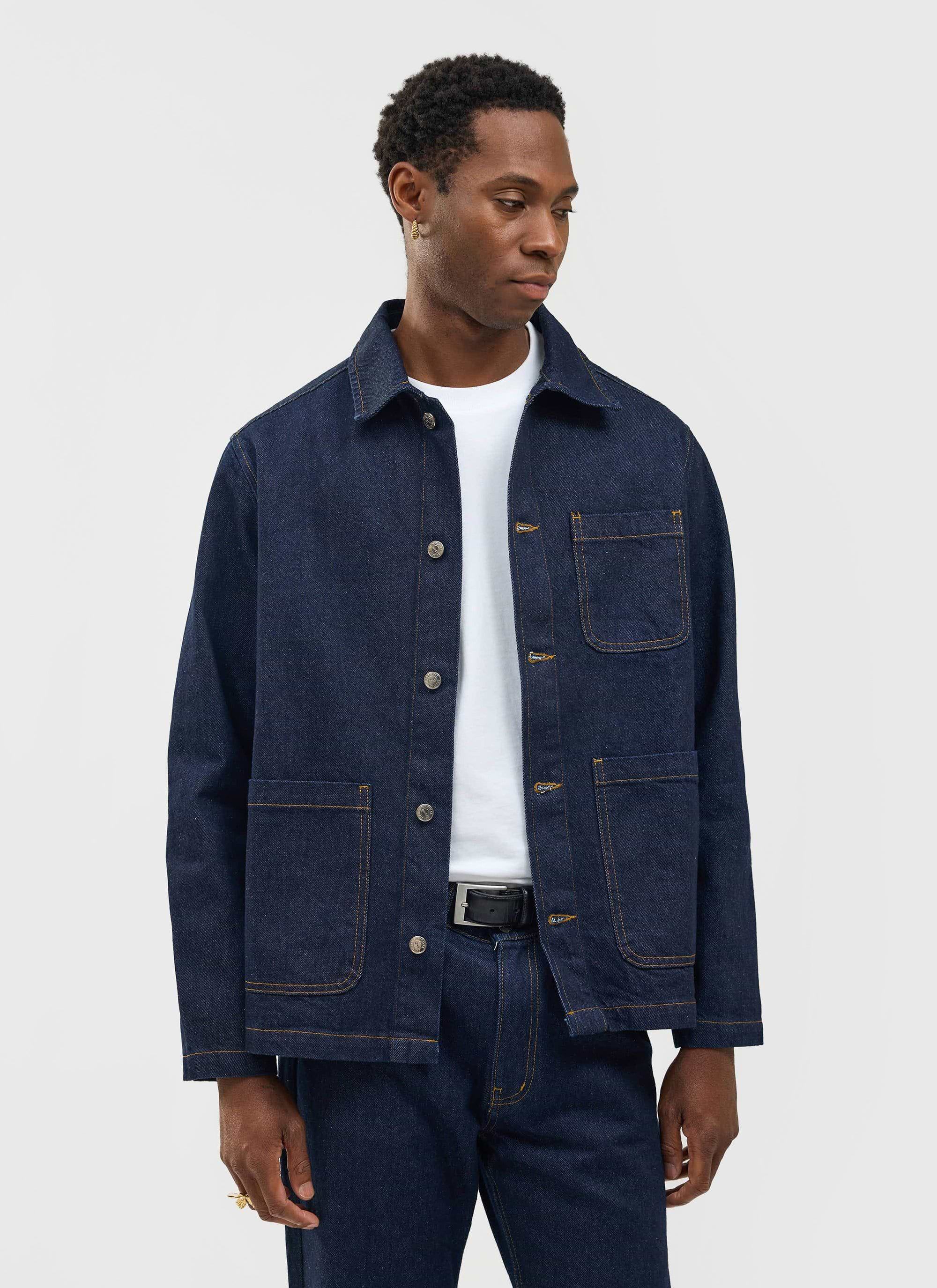 A model wears the Percival Gove Chore Jacket in dark indigo denim, styled with matching jeans and a white t-shirt.