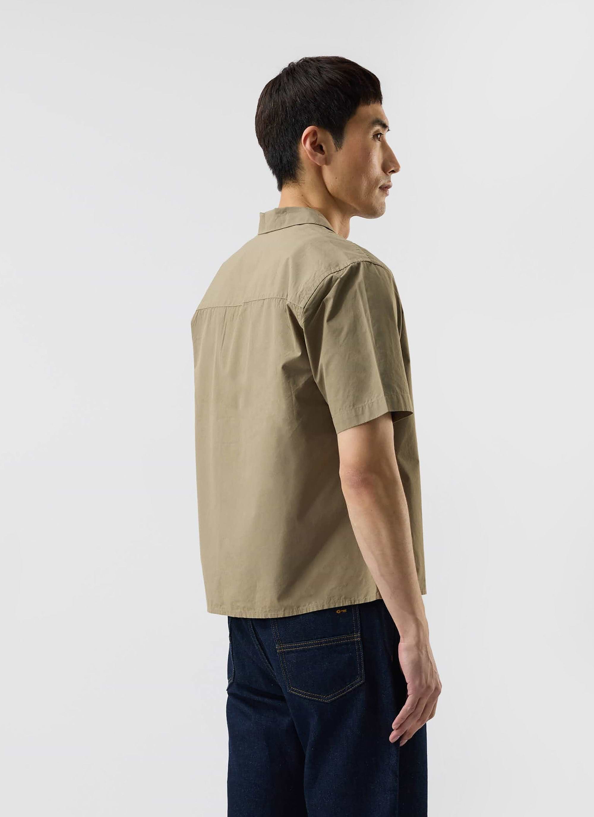A back view of a model wearing the Percival Boxy Cropped Cuban Collar Shirt in olive green, showing the relaxed, boxy fit.