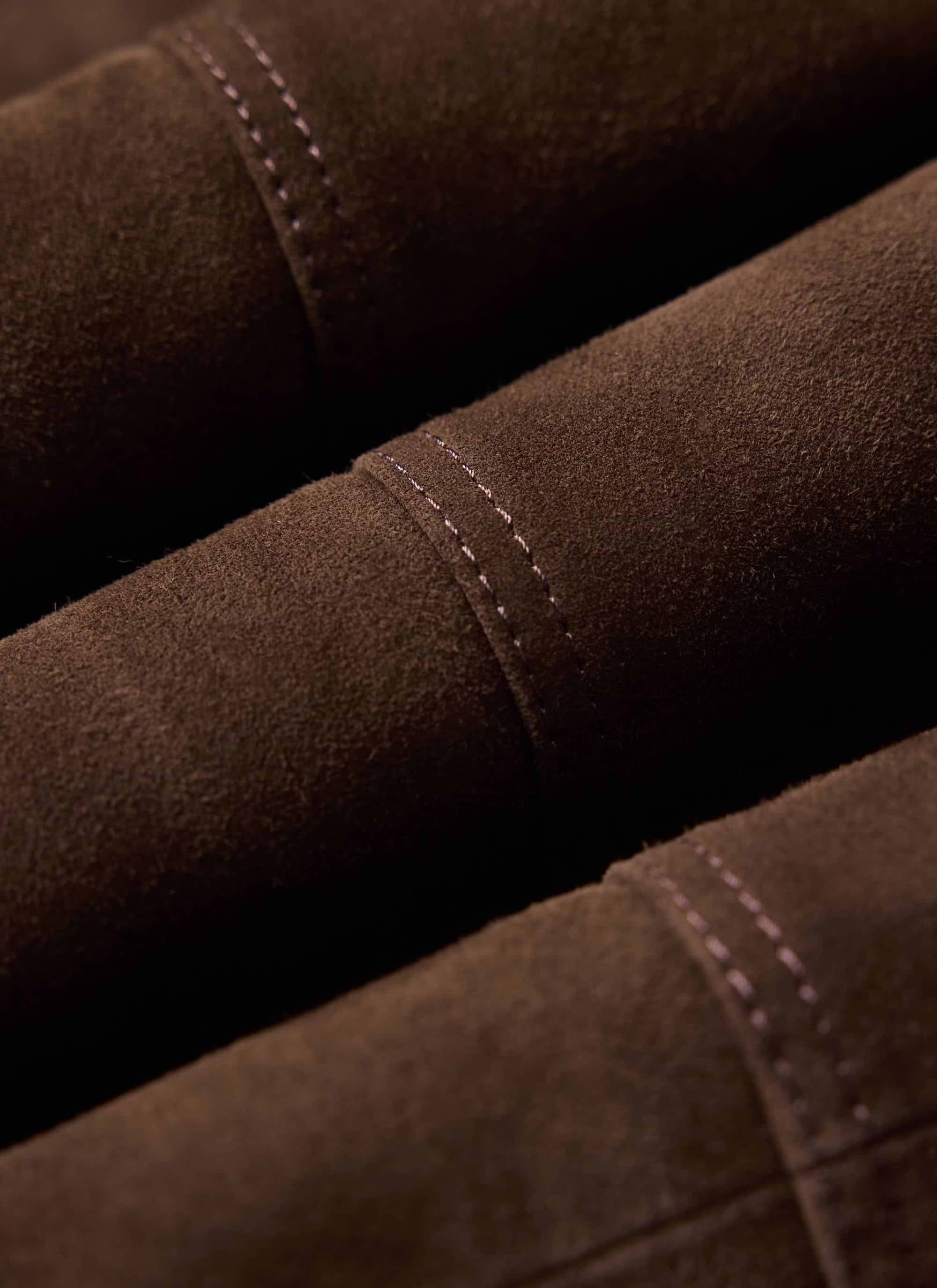 Close up of the Percival Prologue Soft Suede Jacket showing the texture of the espresso brown fabric and stitching.