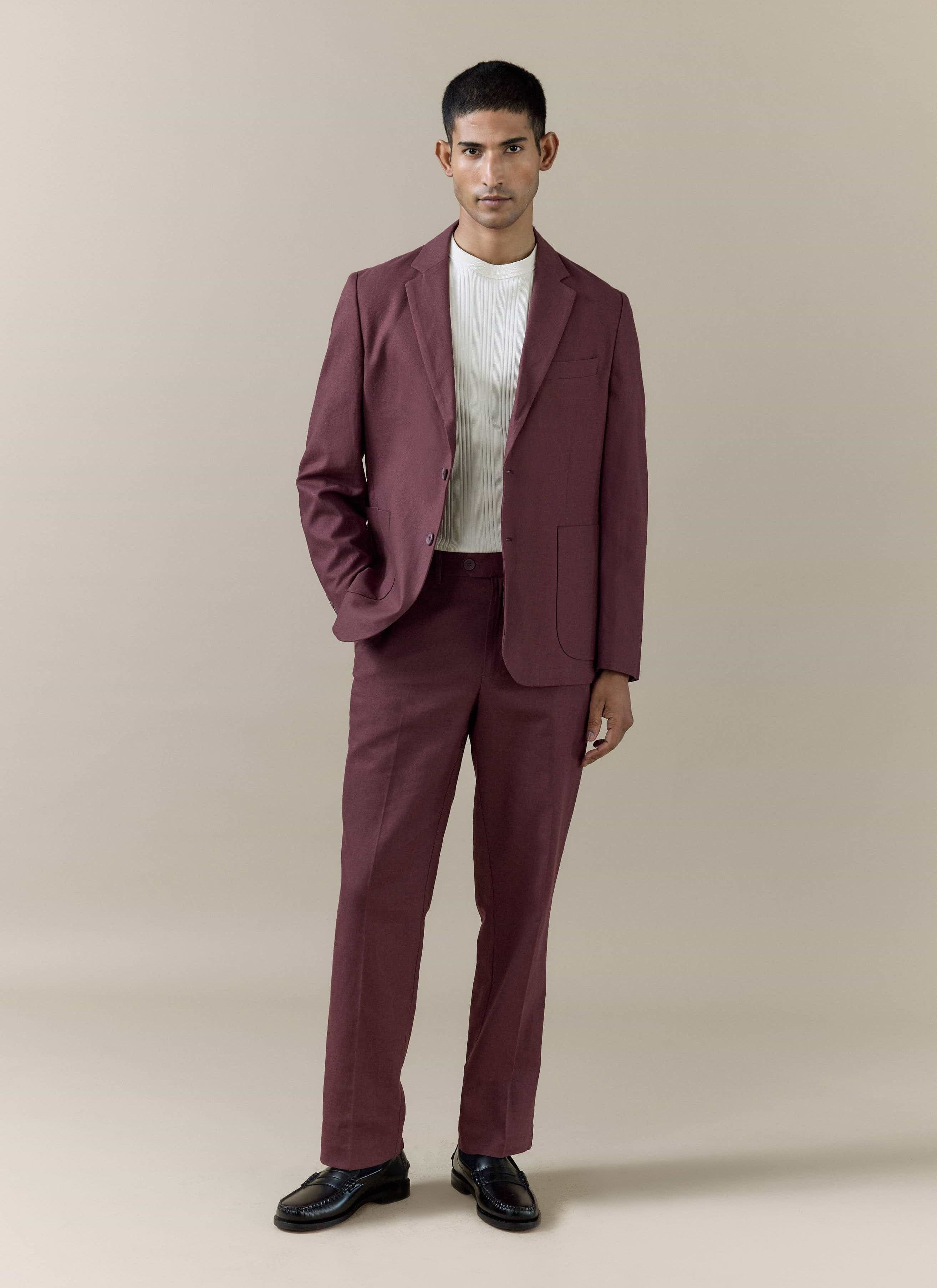 Percival Merlot tailored linen trousers and matching blazer styled with a white top and black loafers.