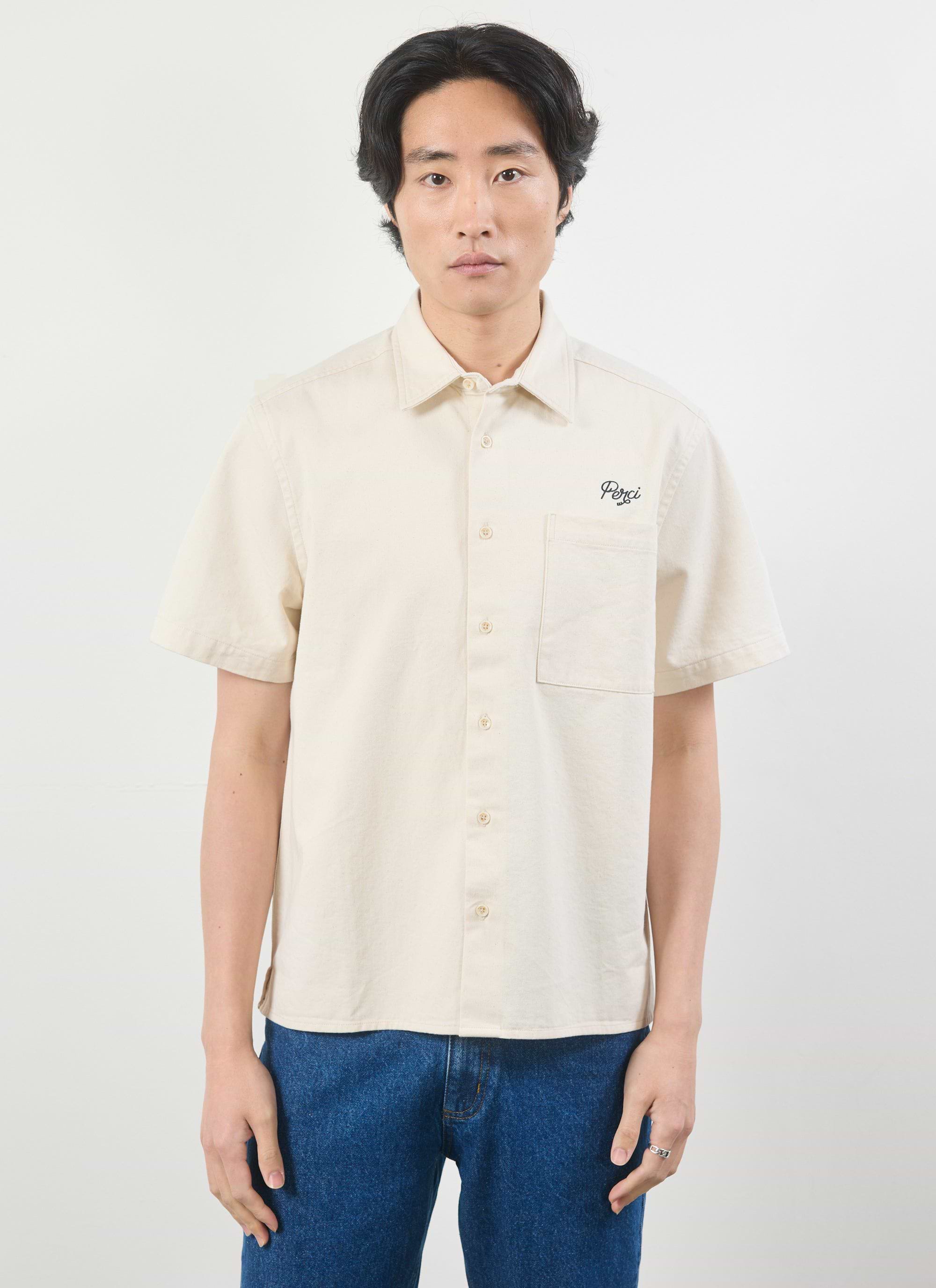 A model wears the Percival Olive Embroidered Cropped Shirt in off-white, showing the front view with Perci chest embroidery.