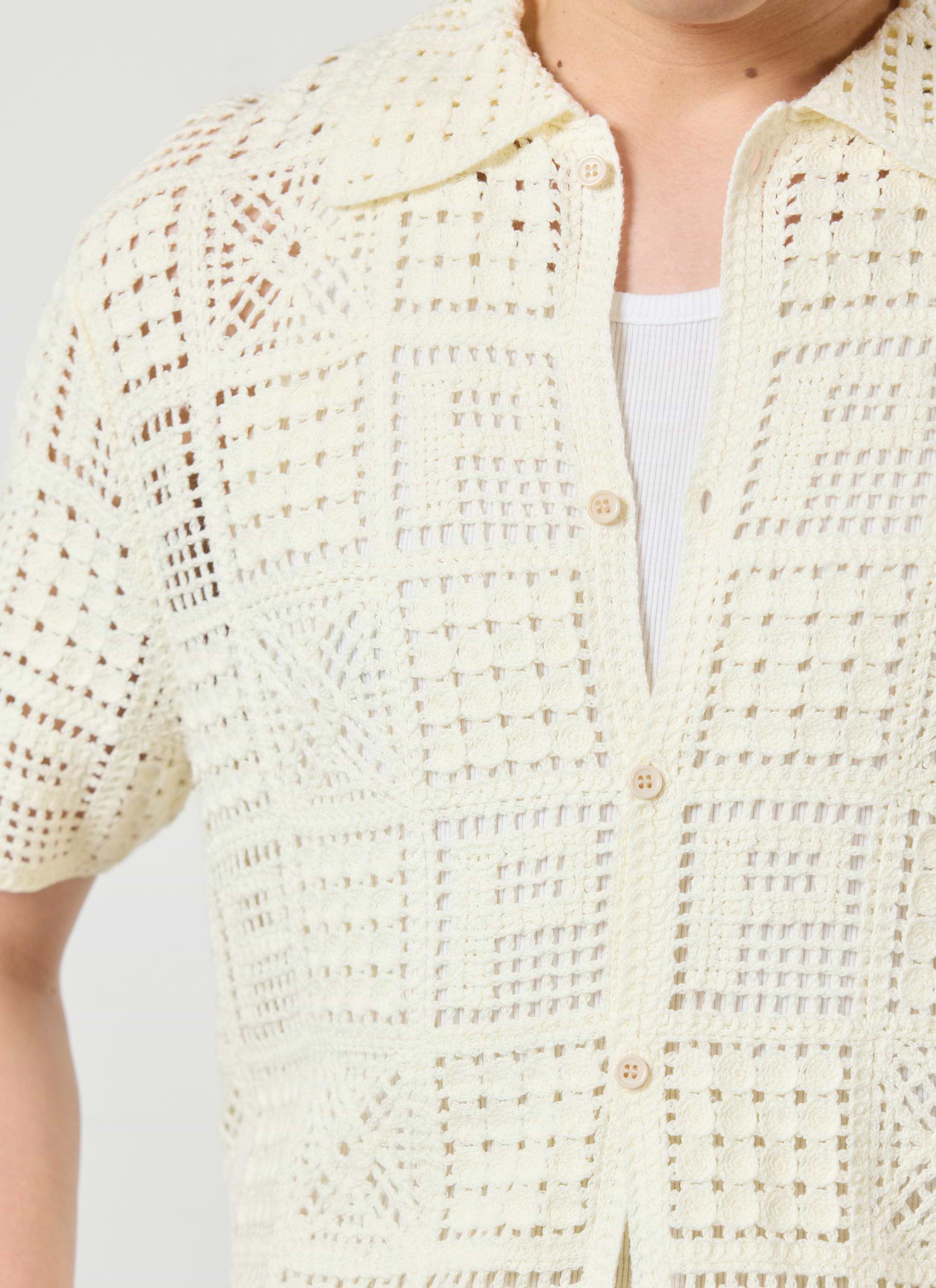 Close-up shot of the Percival Crochet Groundsman Shirt in ecru, showing the intricate cotton crochet pattern on a model.