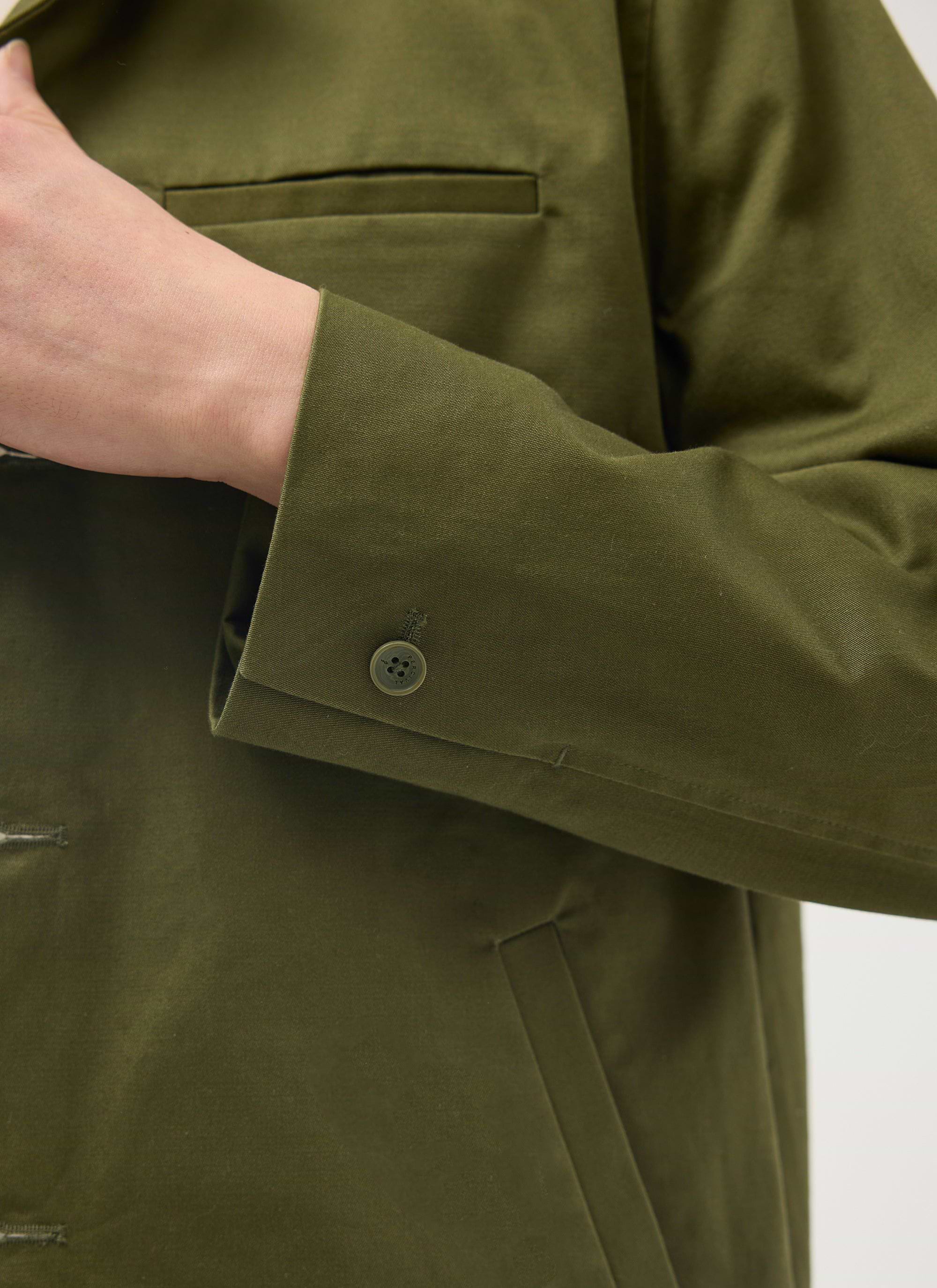 Close-up of the Percival Casual Workwear Jacket in khaki, detailing the cotton sleeve, branded button and jetted pocket.