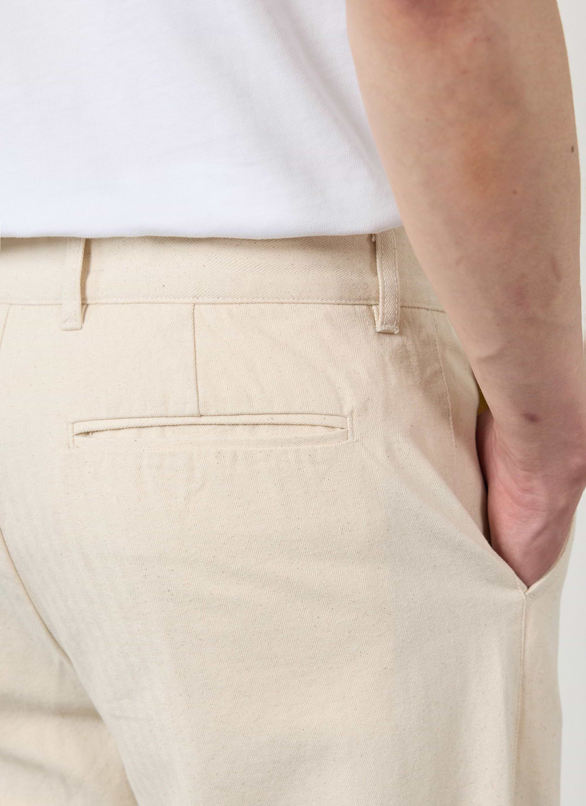 Close up of the back pocket on the Percival ecru cotton Program Pleated Trousers