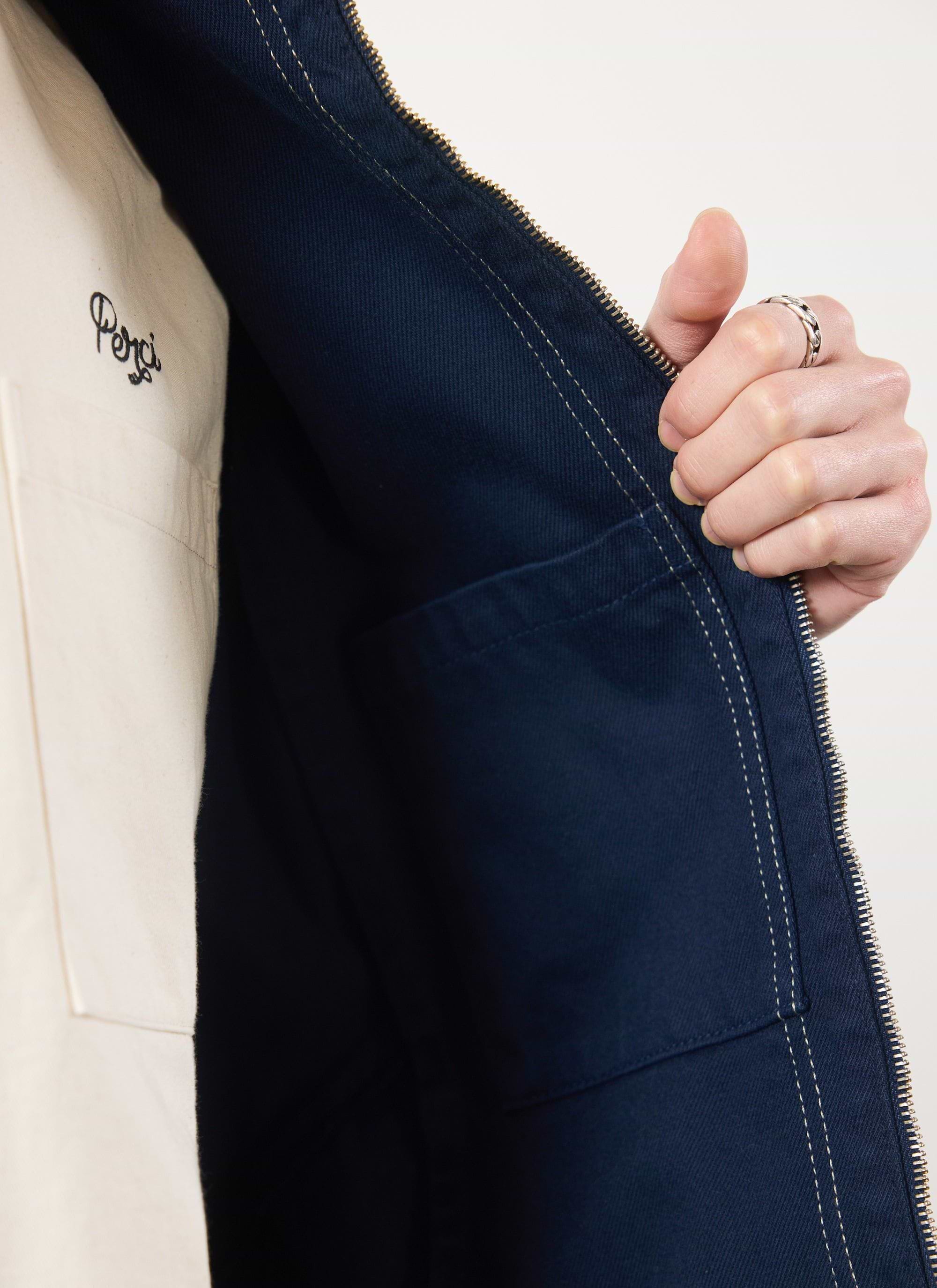 A close-up of the inside of the navy Percival Calabria Harrington jacket, showing the internal pocket and contrast stitching.