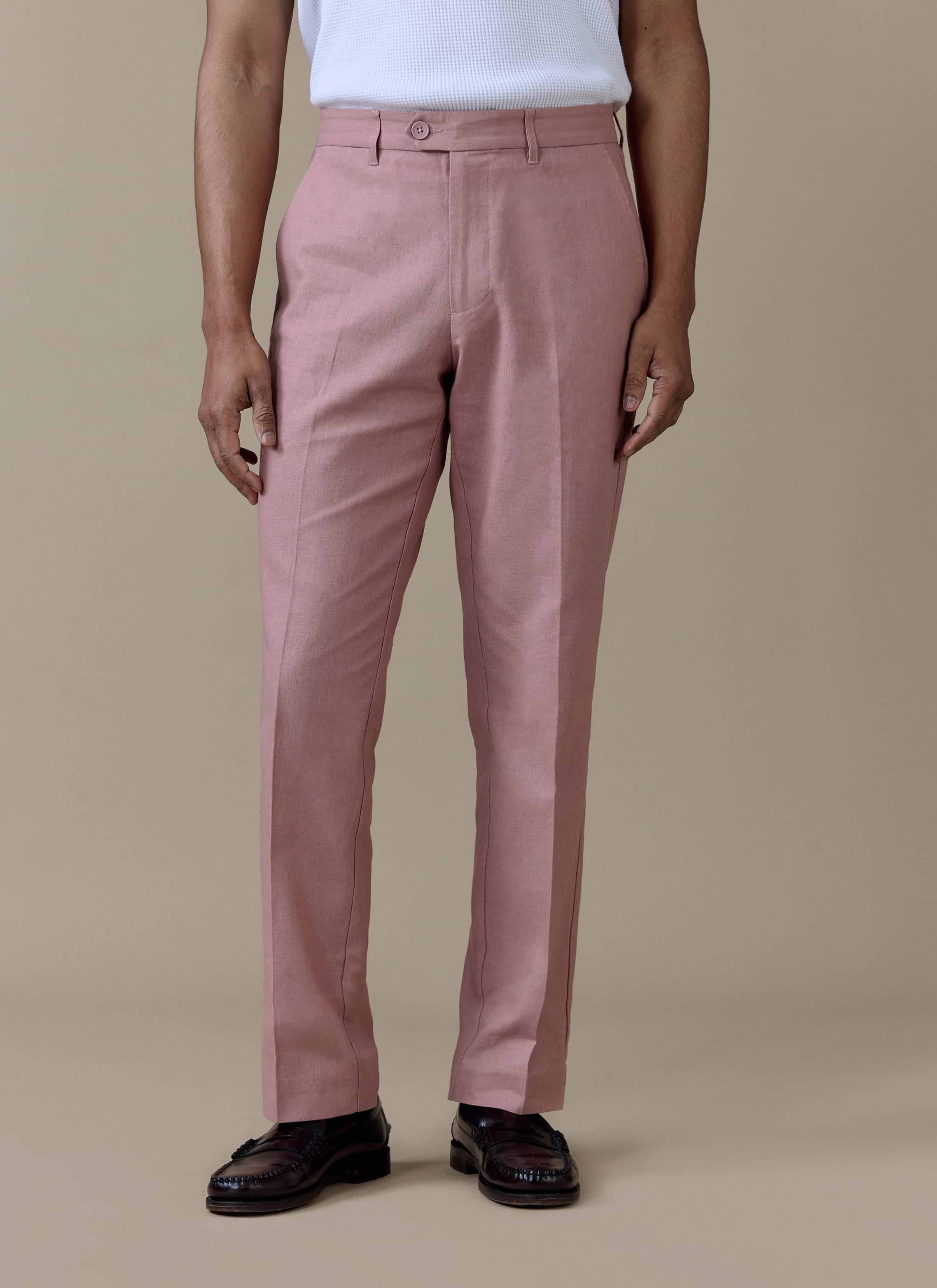 Tailored dusty pink linen trousers by Percival, featuring a sharp centre crease and straight leg fit.