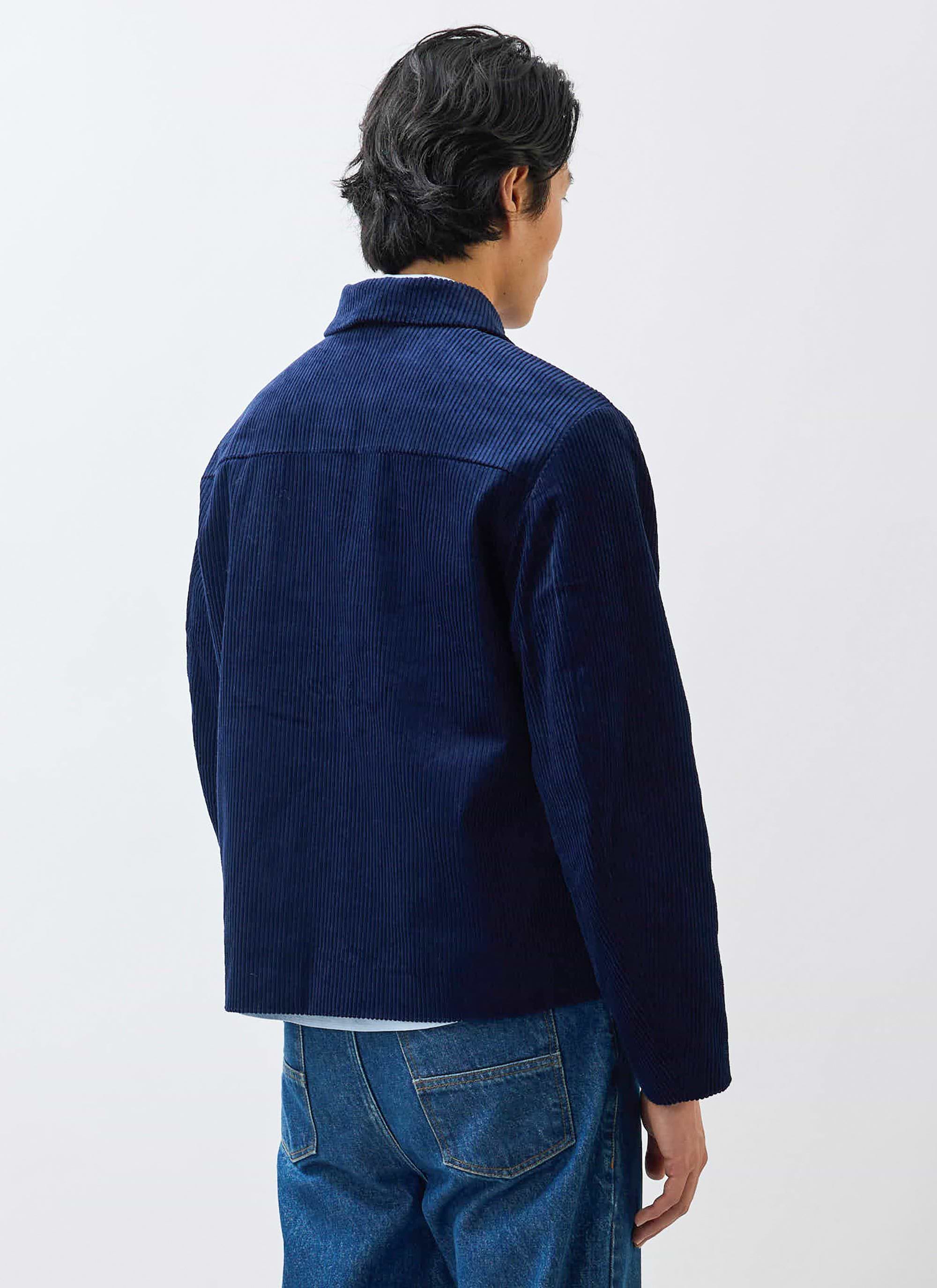 Rear view of a model wearing the Percival navy Cord Overshirt, styled with a pair of classic blue jeans.