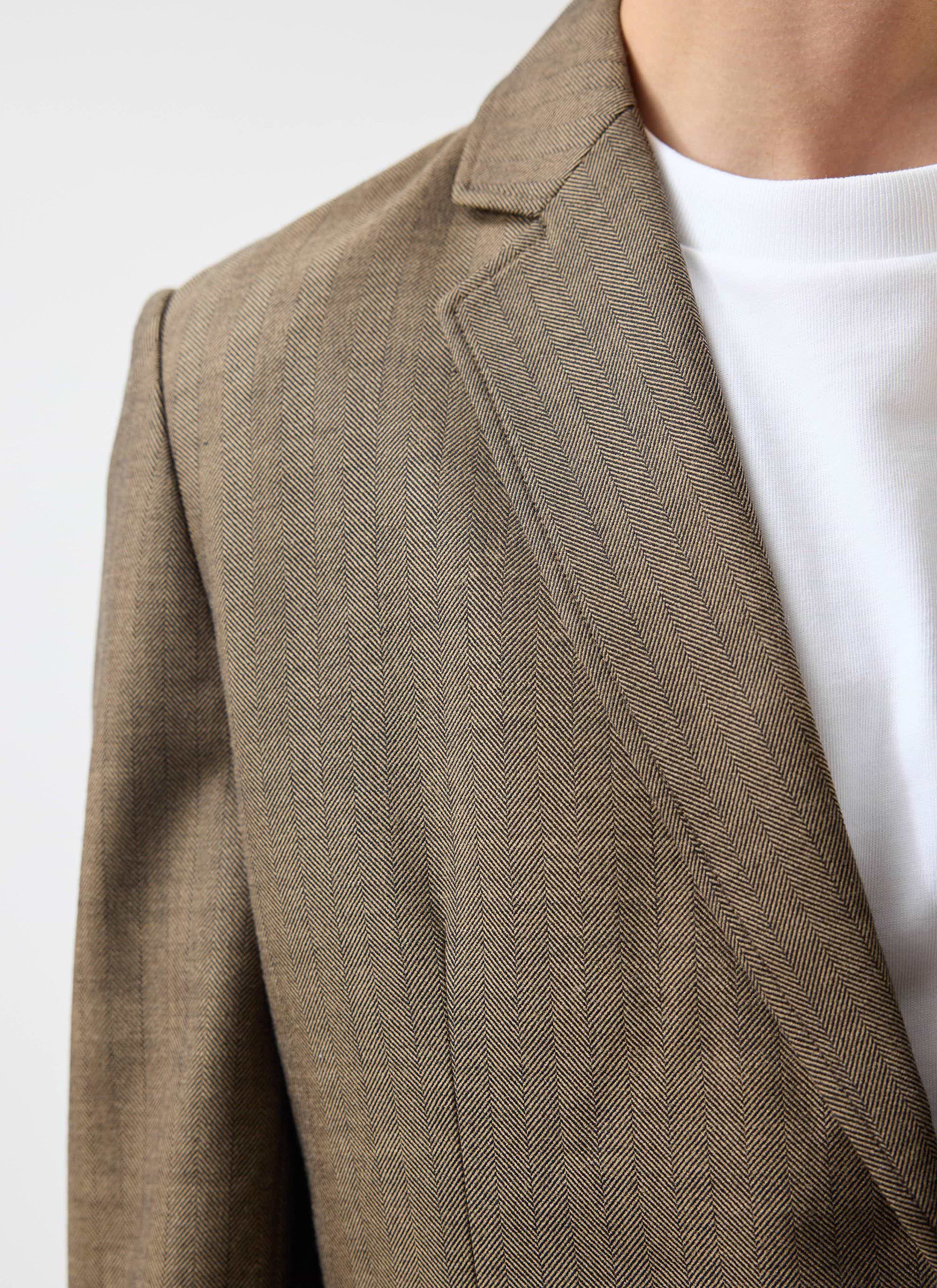 A close-up of the Percival Grounds Tailored Blazer in Oak, showing the herringbone wool texture and lapel detail.