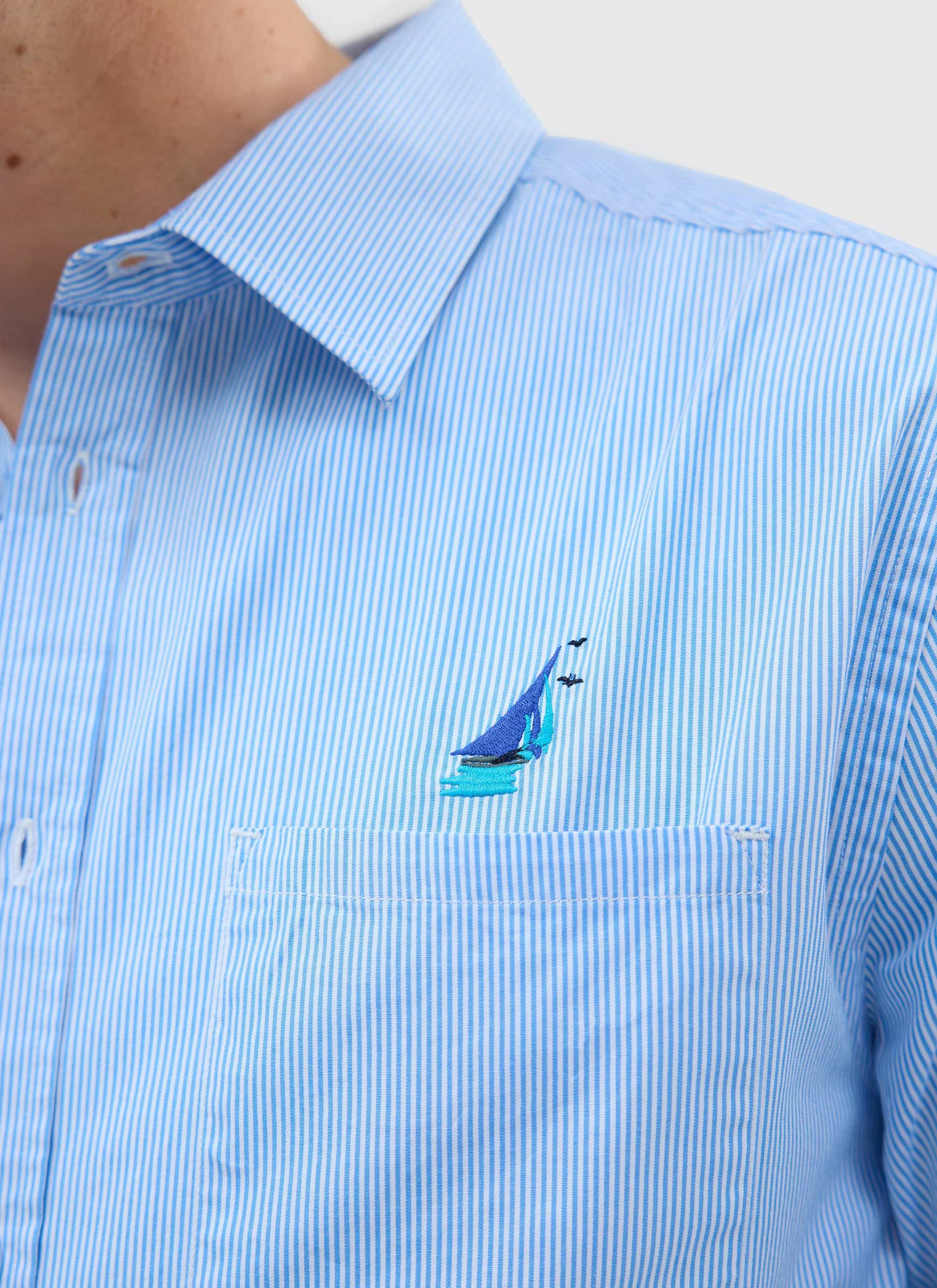 A close-up of the blue and white pinstripe Percival Yacht Shirt, highlighting the custom yacht embroidery on the chest.