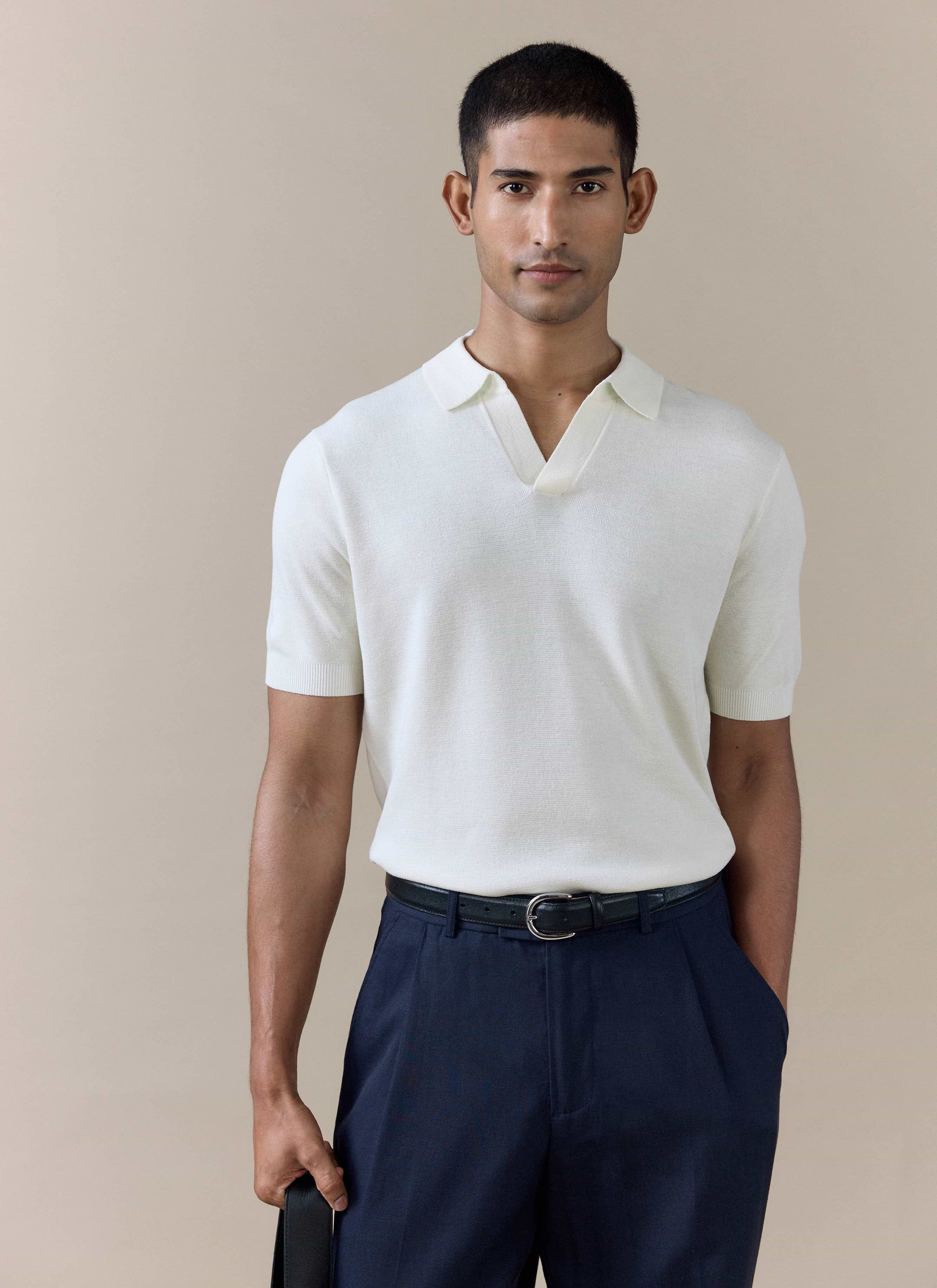Percival Laurence knitted polo in cream linen blend, featuring an open Johnny collar and tailored fit on a male model.