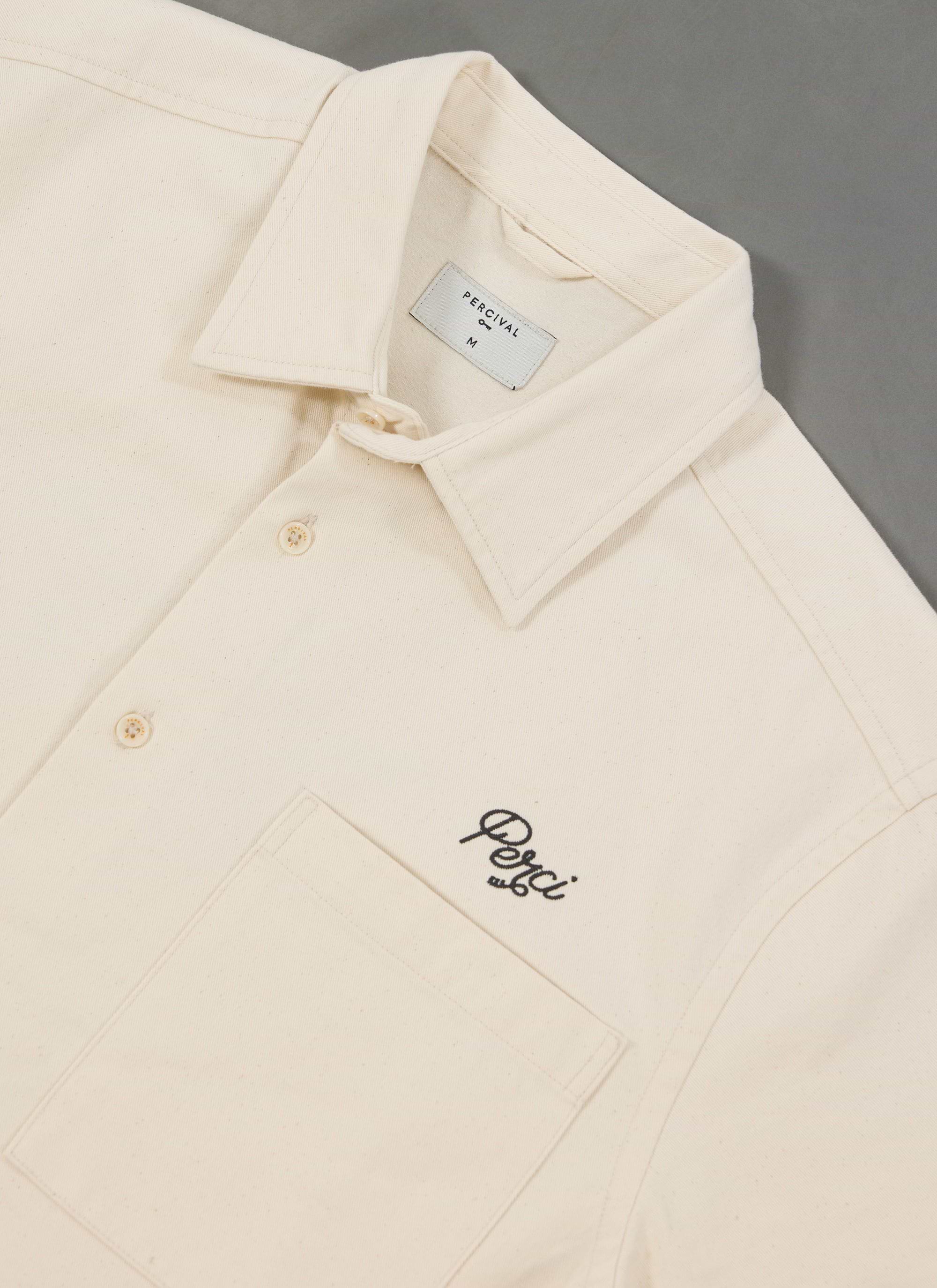 A close-up of the Percival Olive Embroidered Cropped Shirt in off-white, showing the 'Perci' script embroidery on the chest.