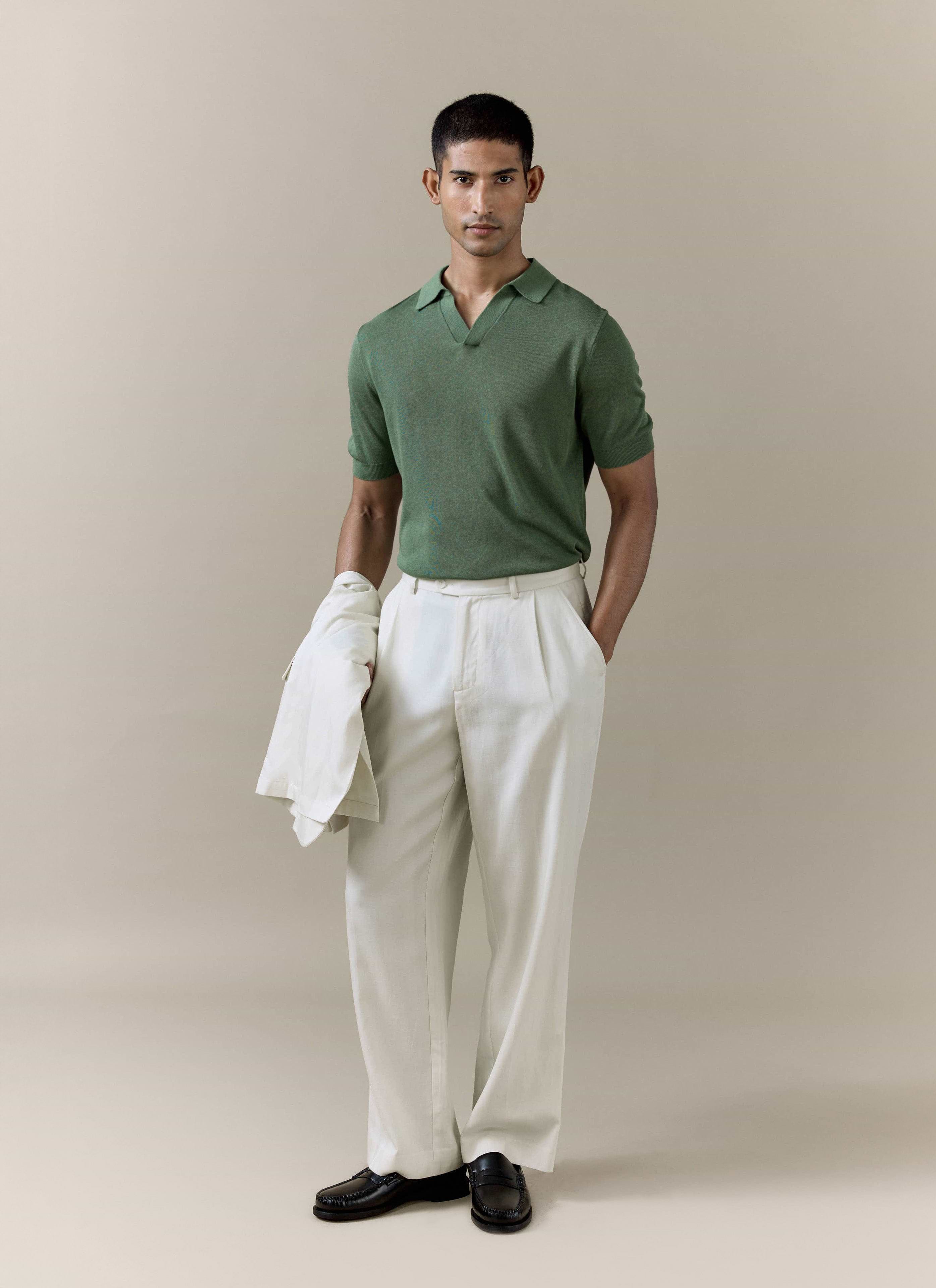 Percival Laurence Knitted Polo in forest green linen blend, styled with cream pleated trousers and a matching jacket.