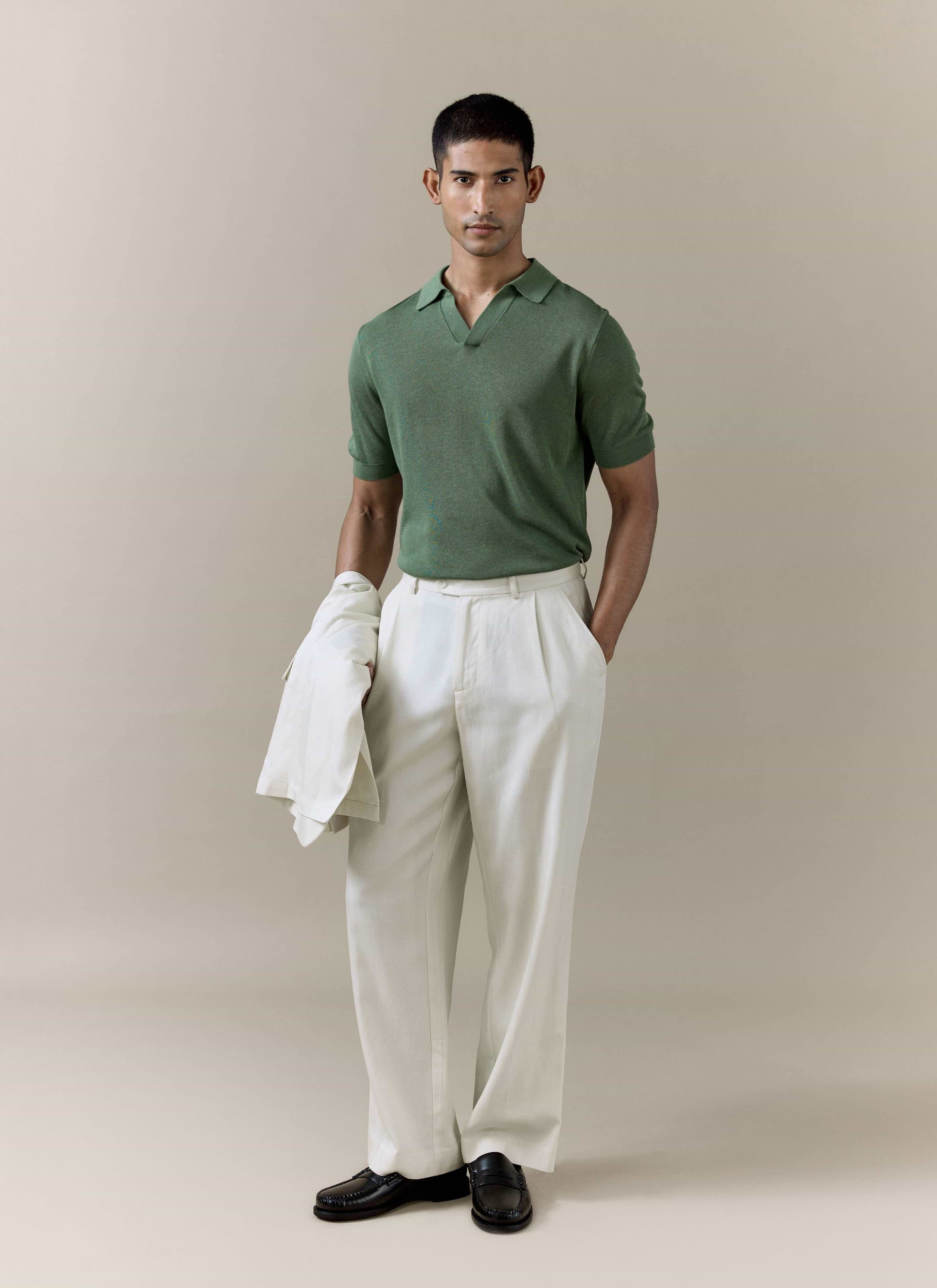 Percival Laurence Knitted Polo in forest green linen blend, styled with cream pleated trousers and a matching jacket.
