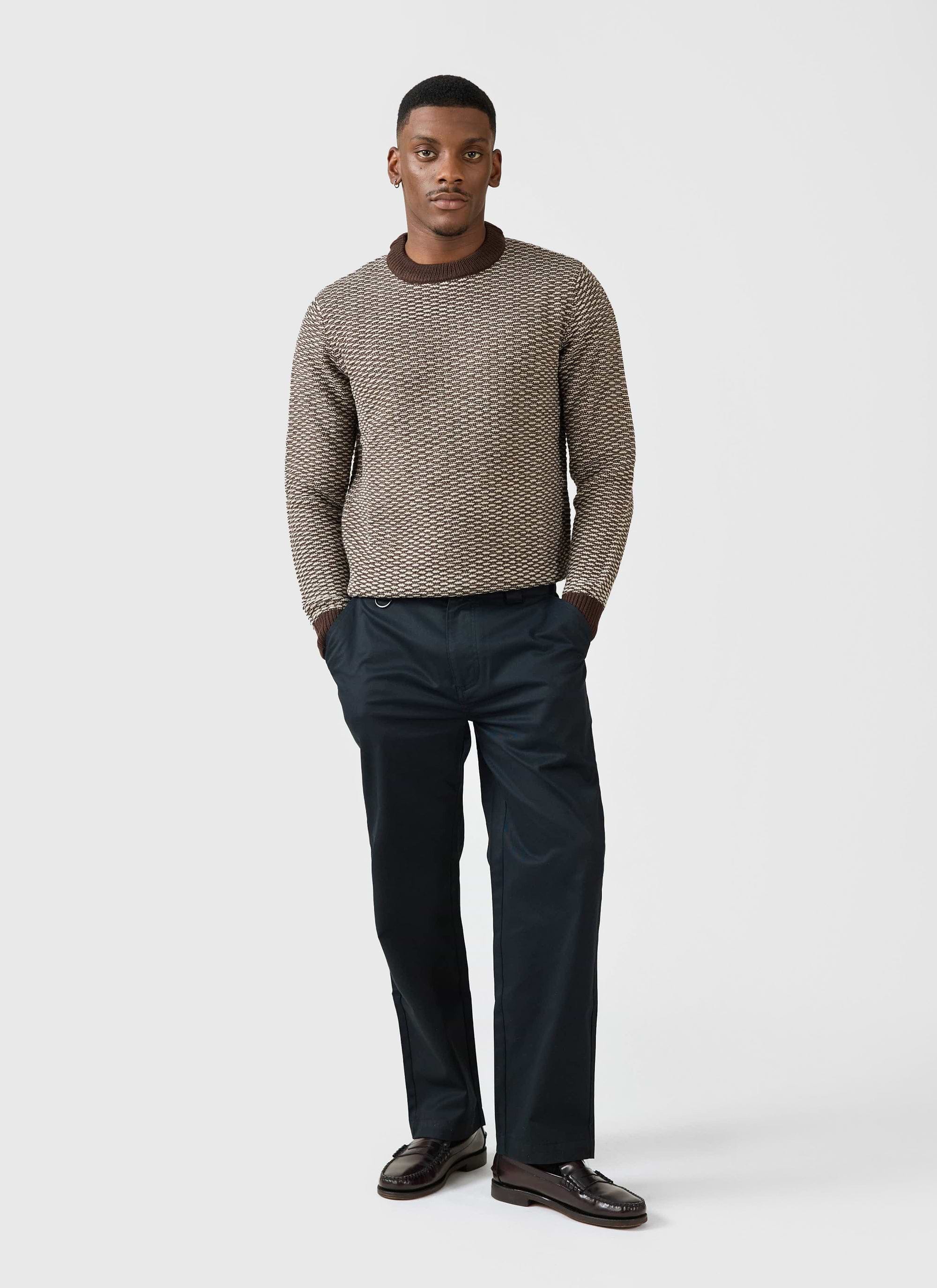 A model wears the Percival Charlestown Knitted Jumper in Chocolate Beige, styled with dark trousers and leather loafers.