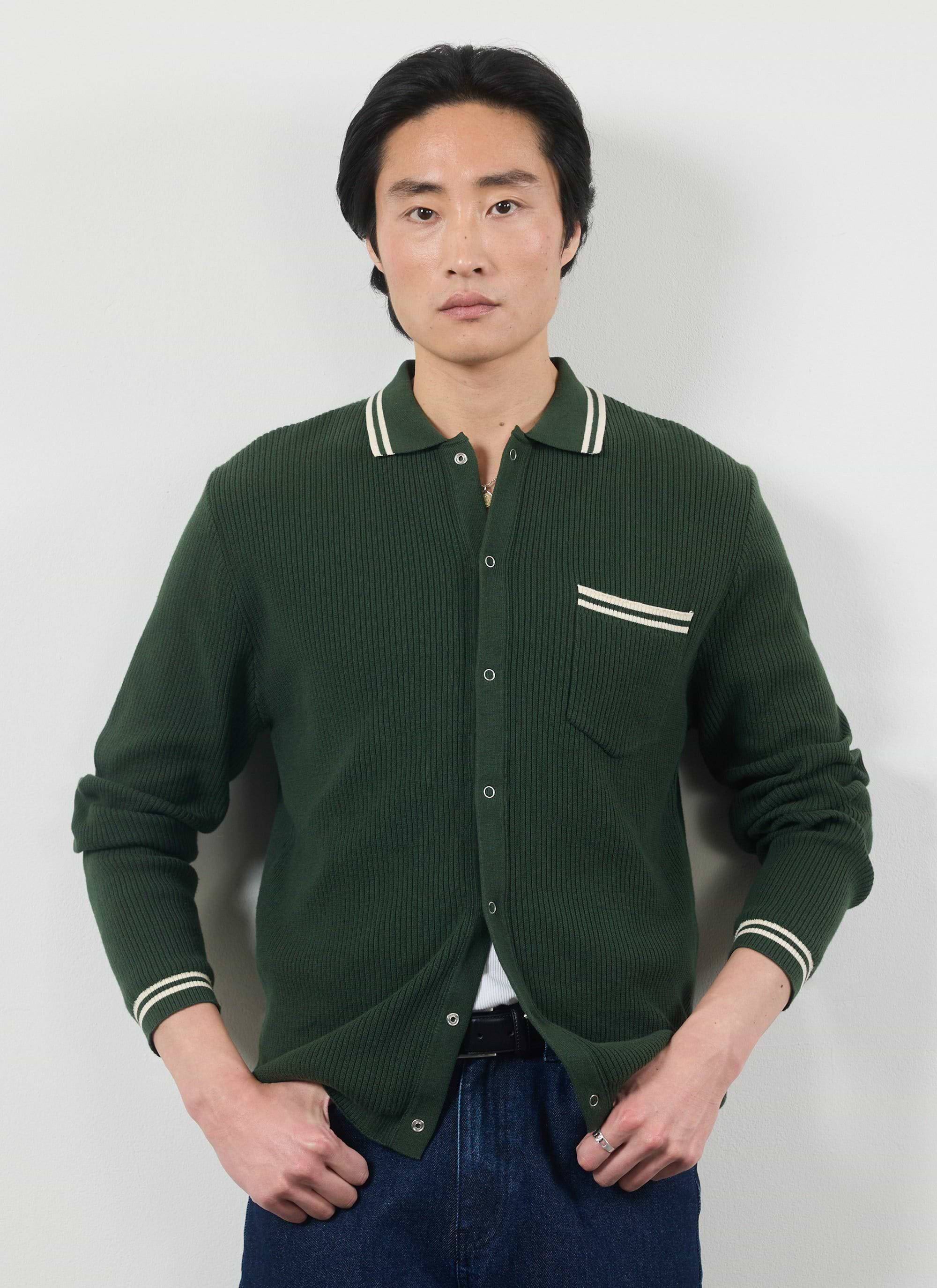 Model wears the Percival Pablo long sleeve cotton knitted shirt in forest green with white tipping on the collar and pocket.