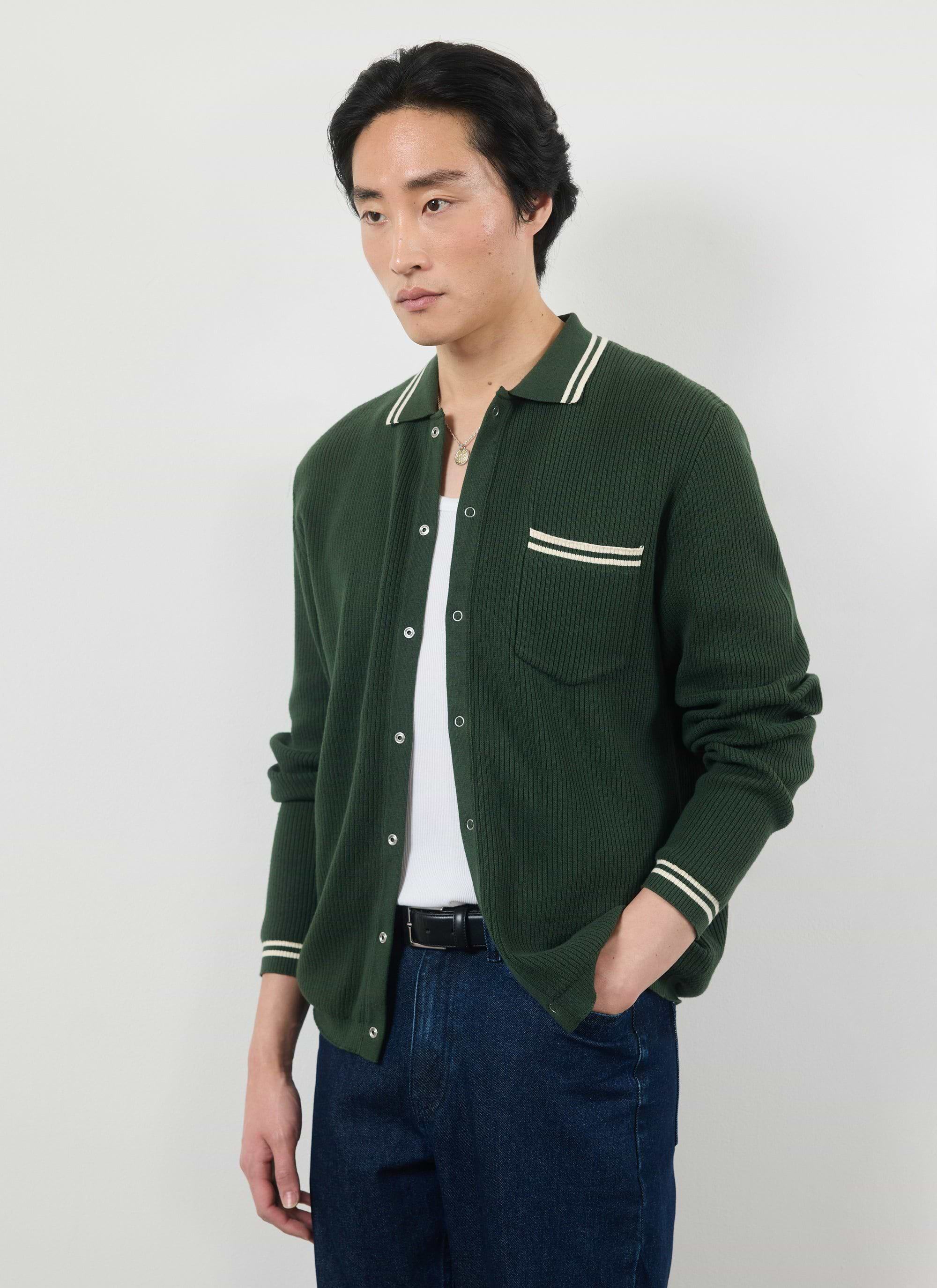 A model wears the Percival Pablo knitted shirt in forest green with white tipping details over a t-shirt and jeans.