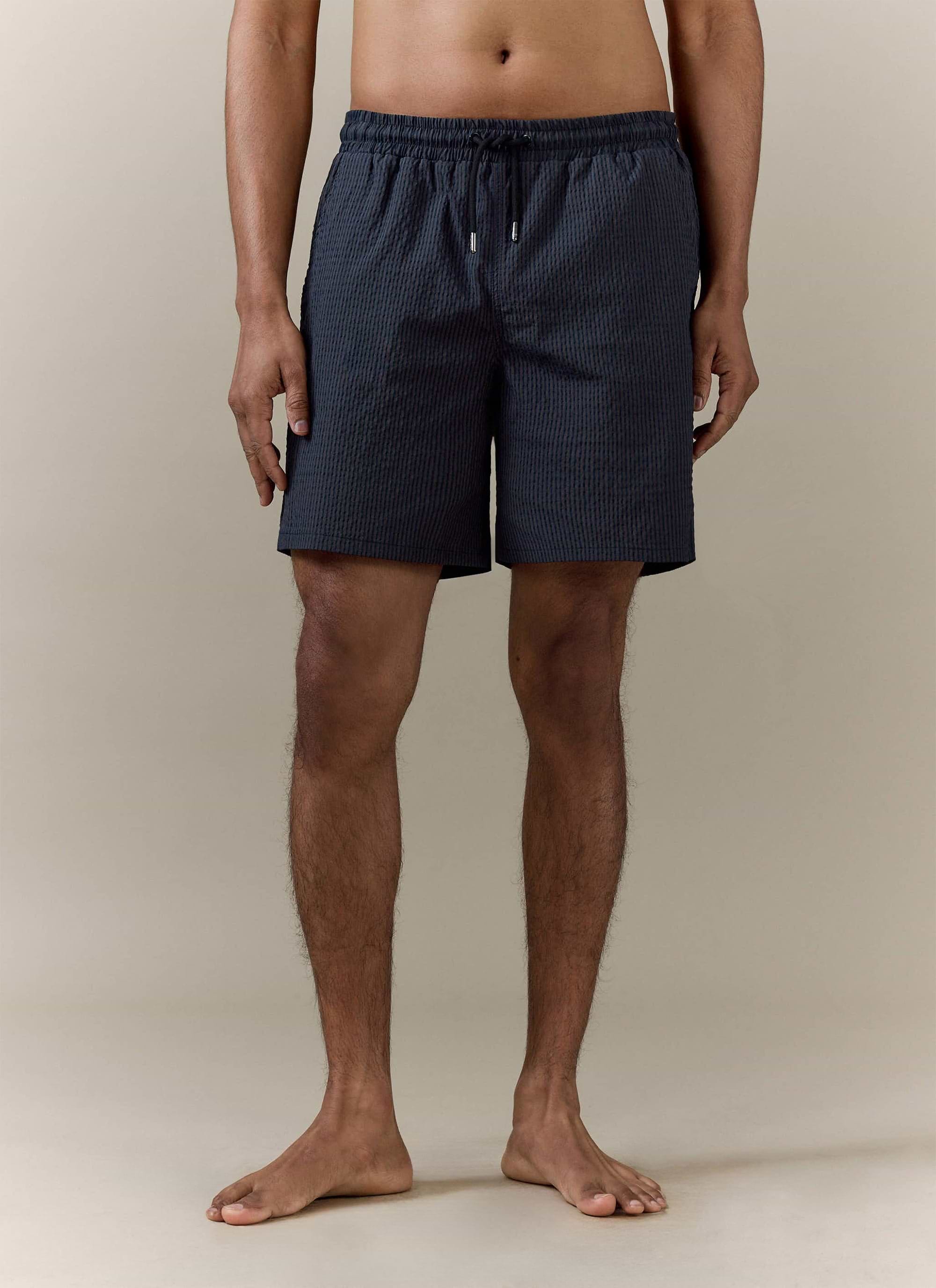 Percival Rowan Seersucker Swim Shorts in navy stripe, featuring a drawstring waist and textured cotton blend fabric.
