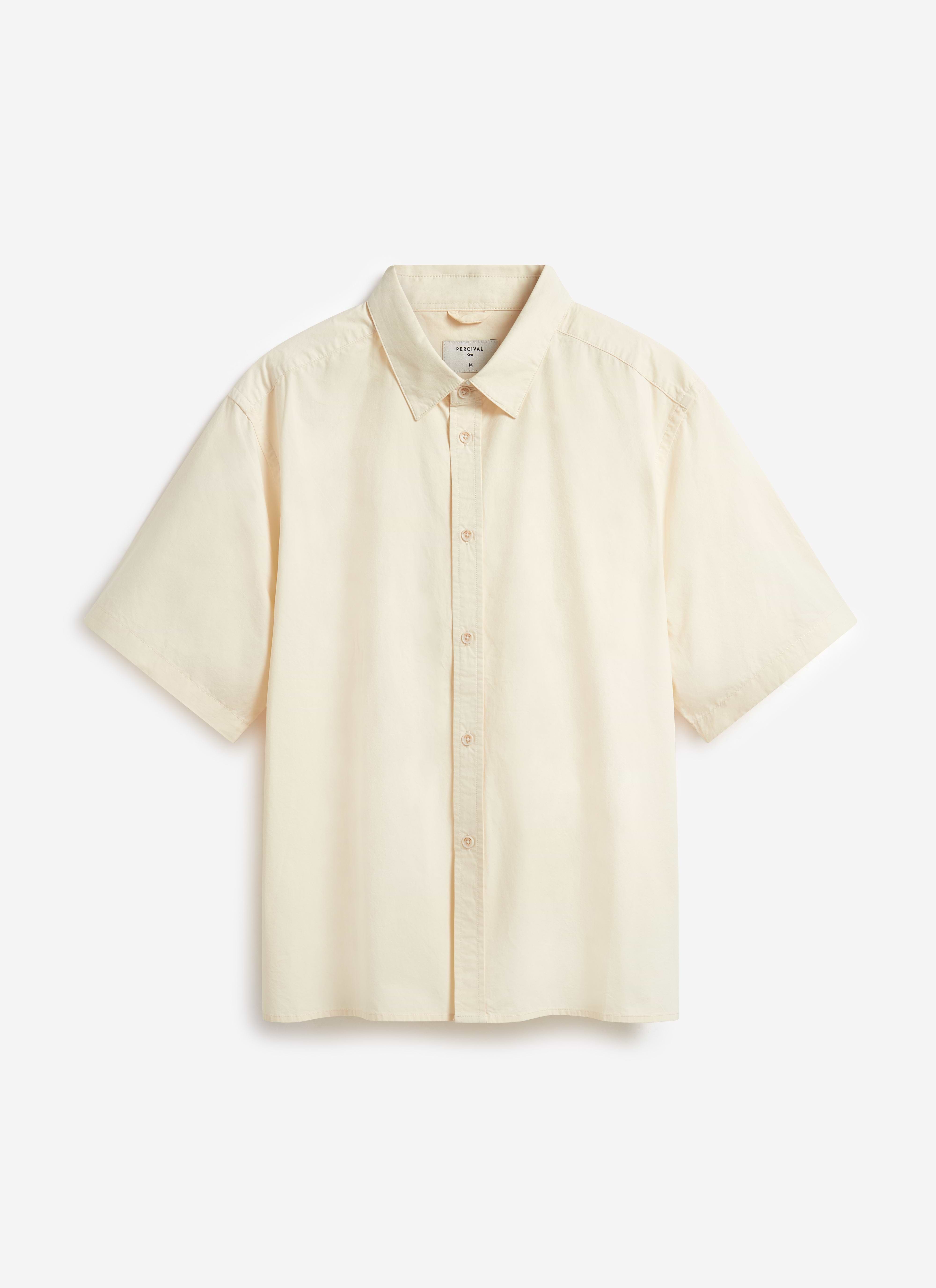 A flat lay of the Percival Boxy Cropped Clerk Shirt in ecru, made from a lightweight paper-touch cotton.