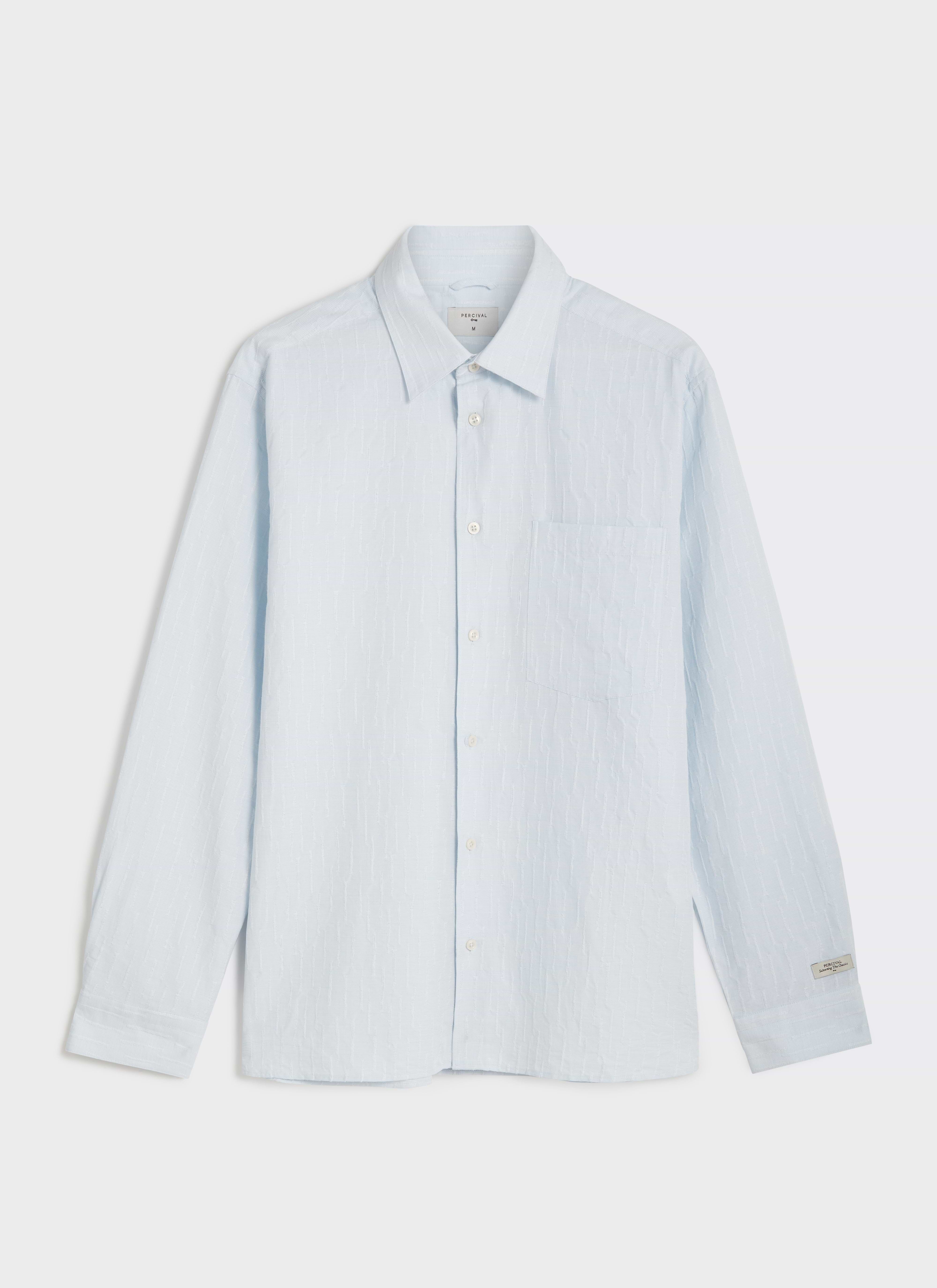 A flat lay of the light blue Percival Paros Pearce long sleeve shirt in textured cotton seersucker fabric.