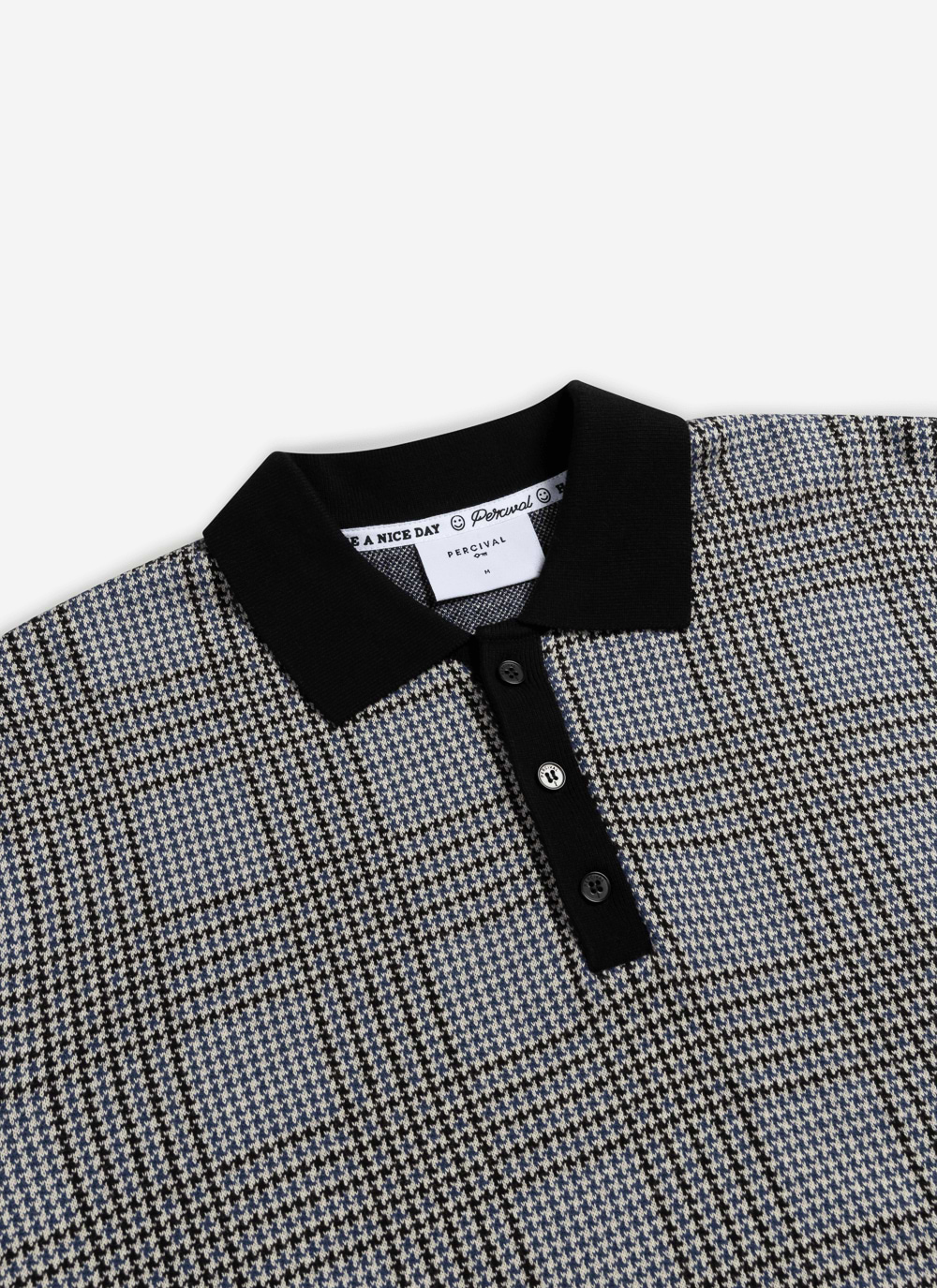Close-up of the Percival Casa Martini Knitted Polo in navy, highlighting the cotton puppytooth pattern and black collar.