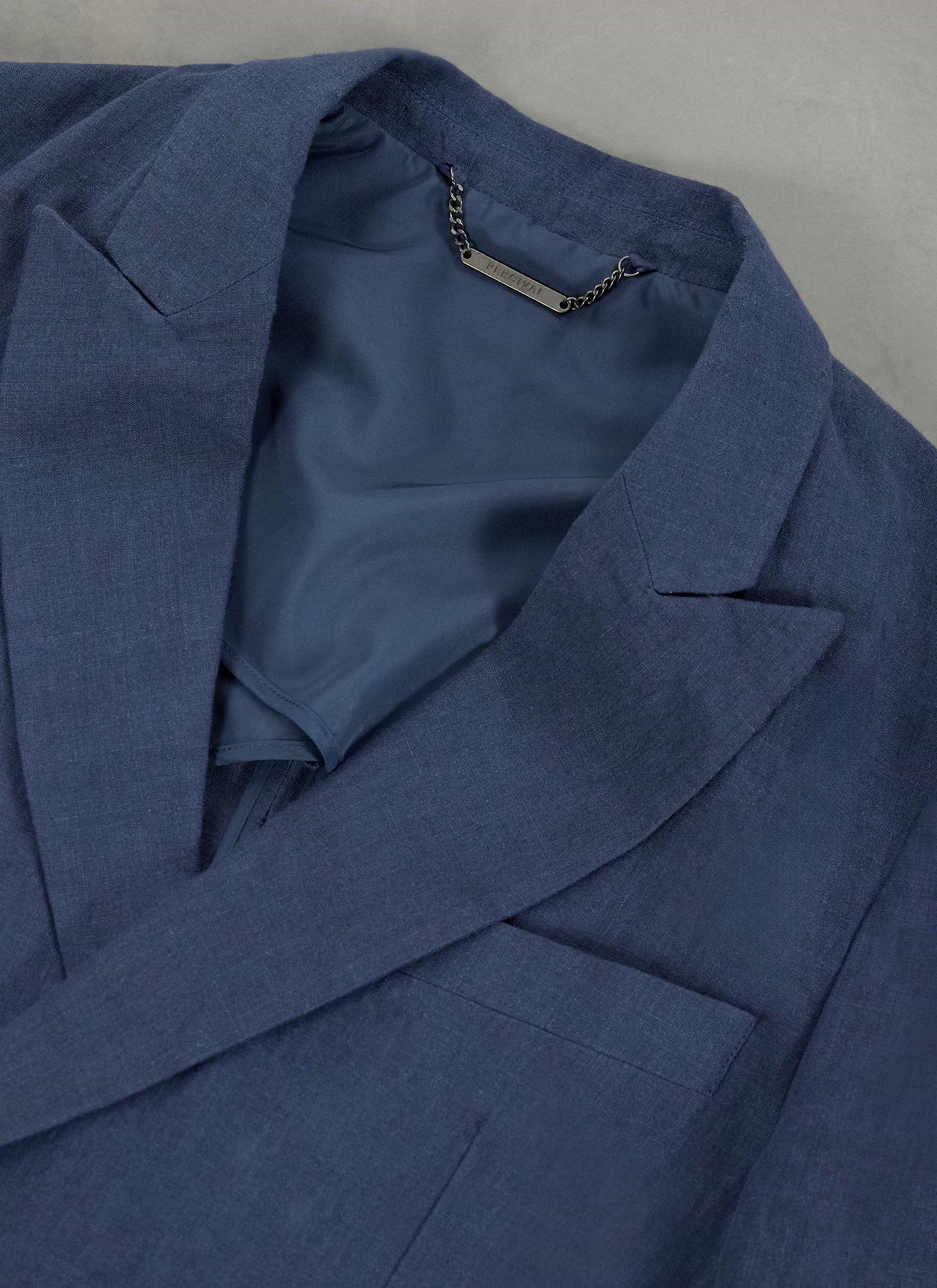 Close up of the Percival navy linen double breasted blazer's collar, lapel and inner branded chain.