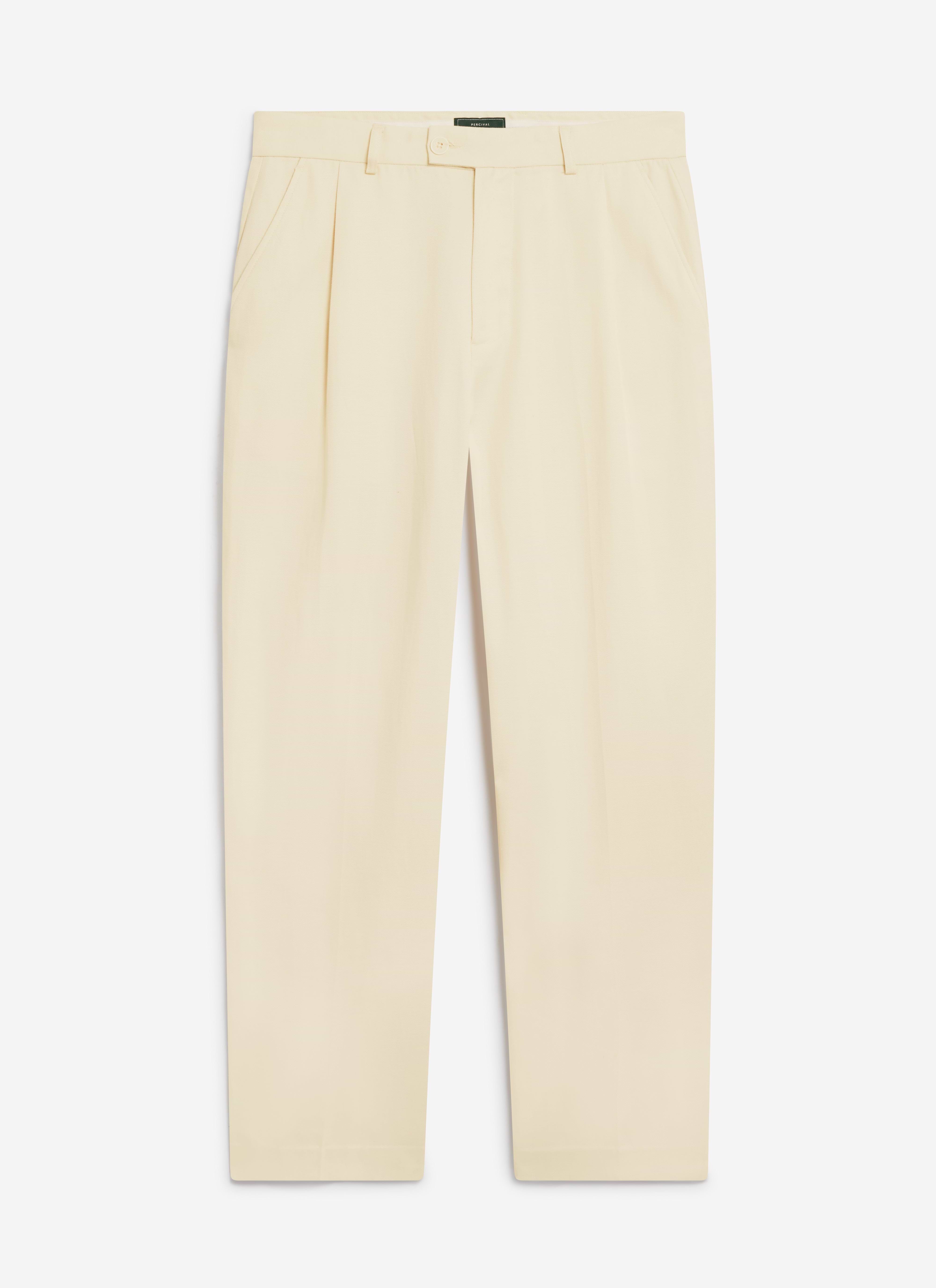 A flat lay of the Percival Pleated Tailored Trousers in cream, showcasing the soft Lyocell fabric and relaxed fit.