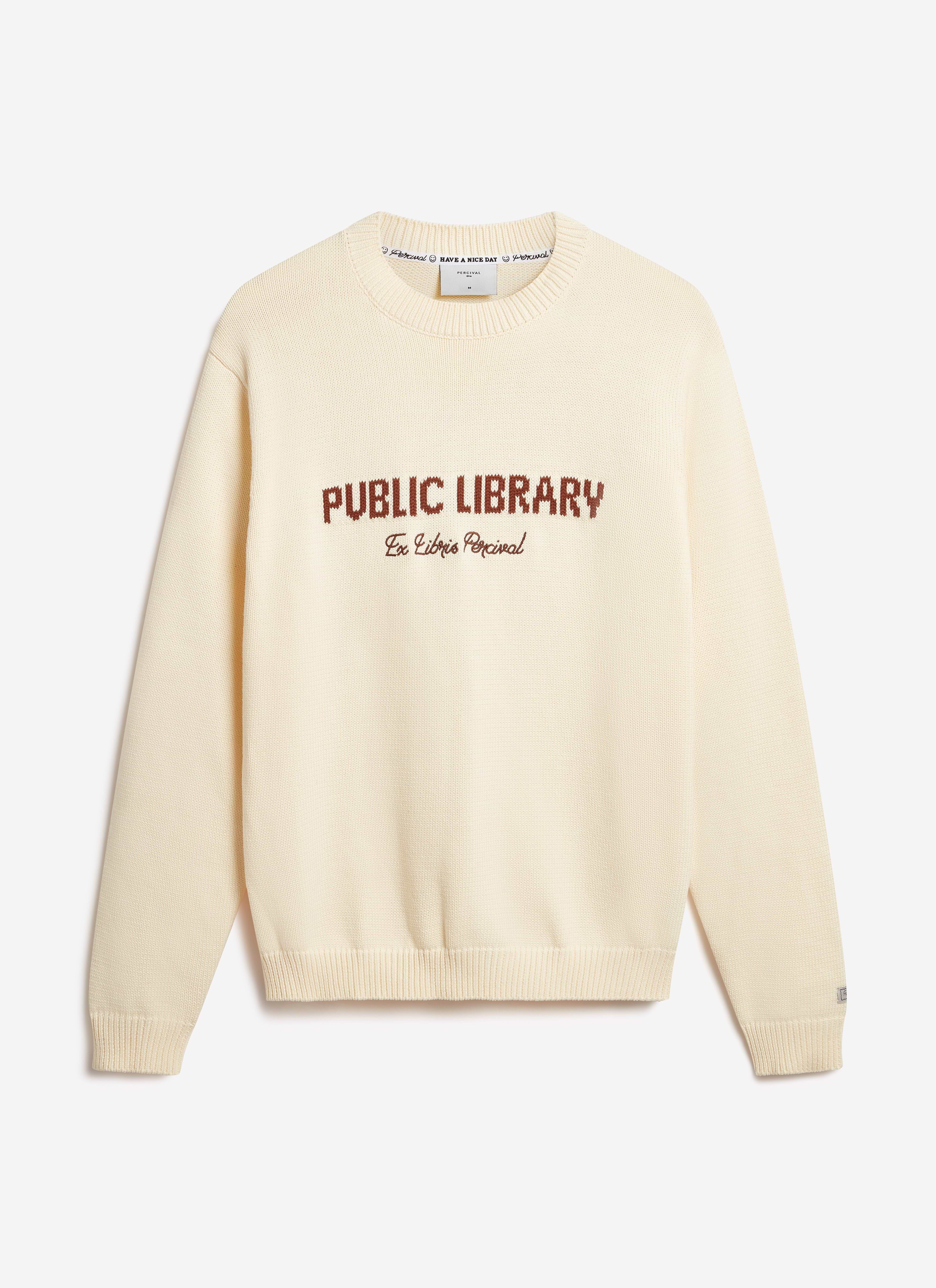The Percival Public Library wool-blend jumper in ecru, laid flat to showcase its 'Ex Libris Percival' chest embroidery.