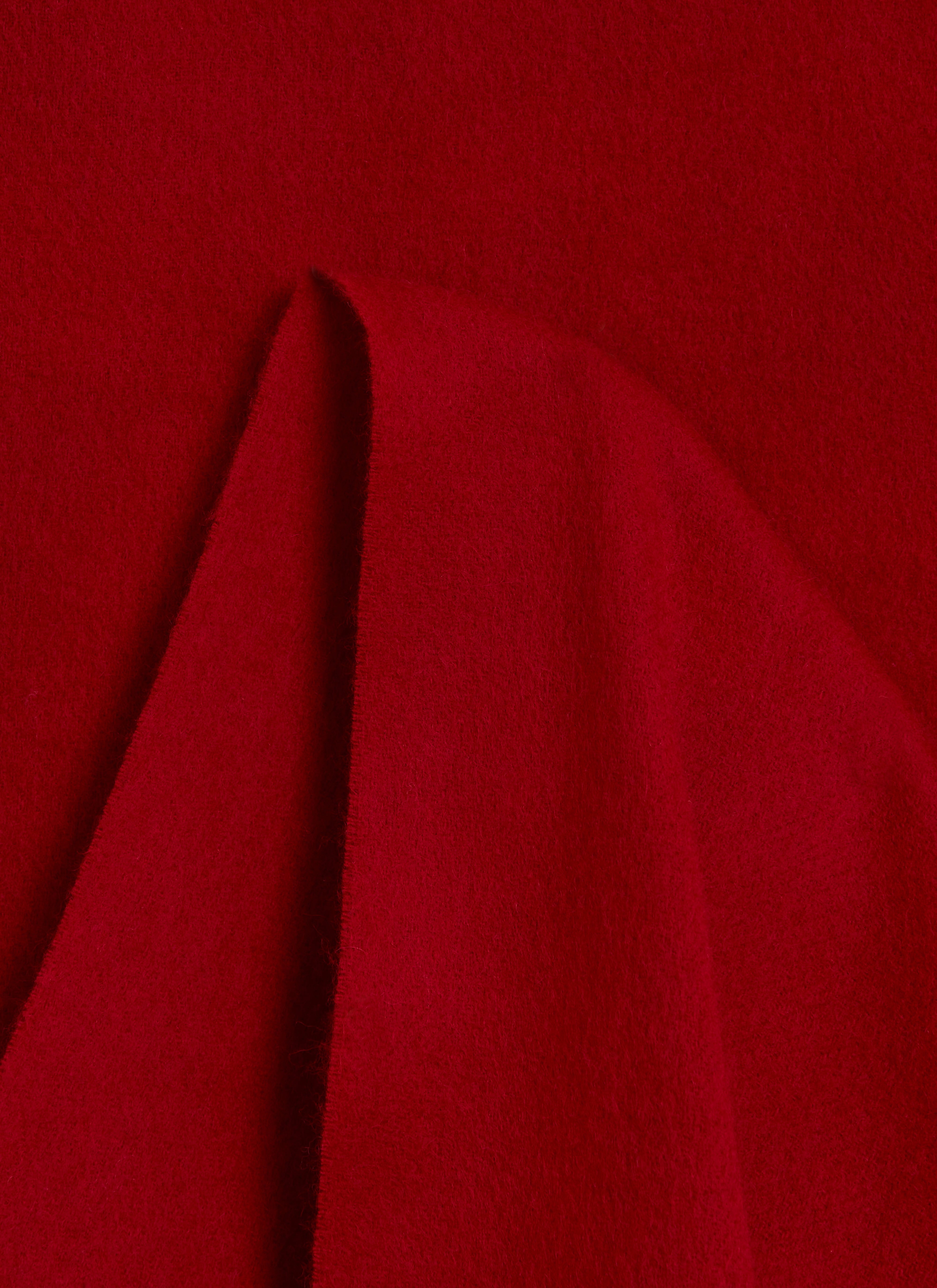 A close-up shot of the Percival Tolkein Scarf, highlighting the soft texture of the red 100% wool fabric.