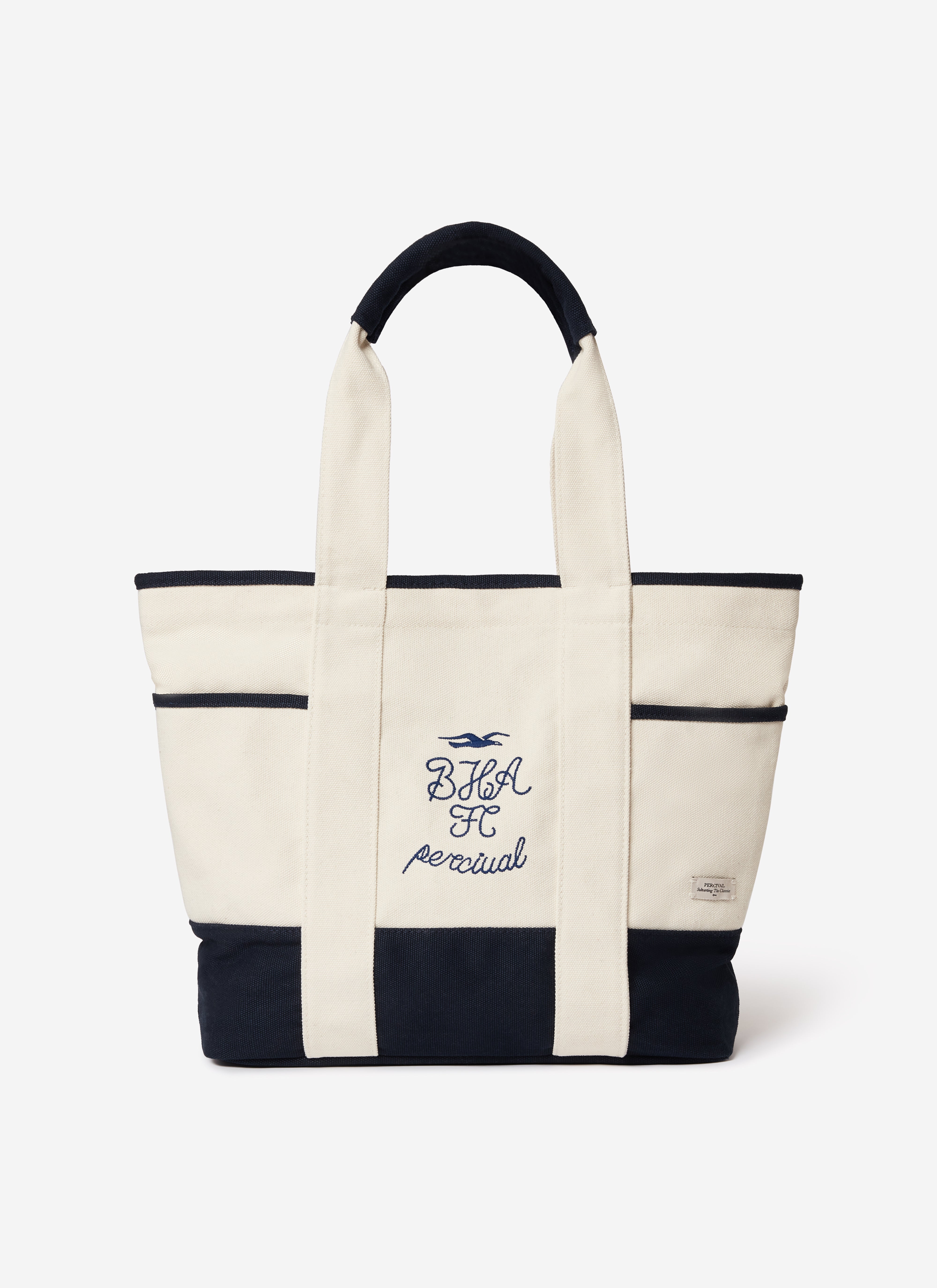 A front view of the Percival x Brighton & Hove Albion F.C. tote bag in cream canvas with navy trim and embroidery.