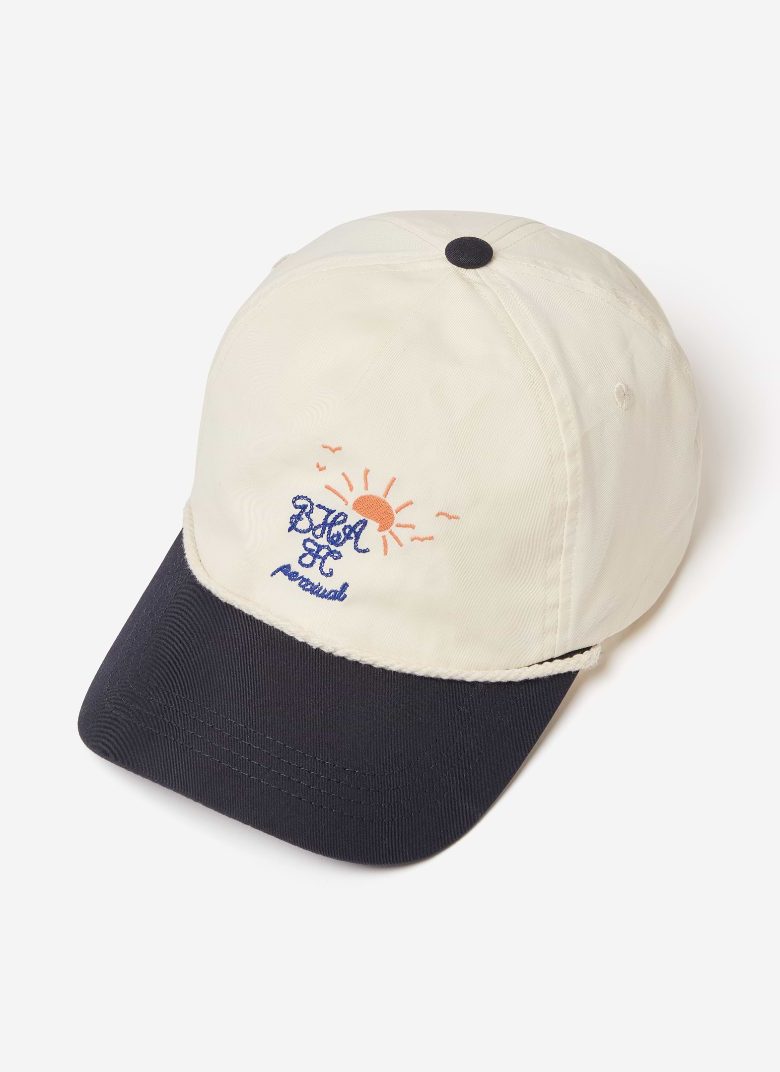 A cream and navy Brighton & Hove Albion F.C. x Percival trucker cap with sun embroidery and rope detail.