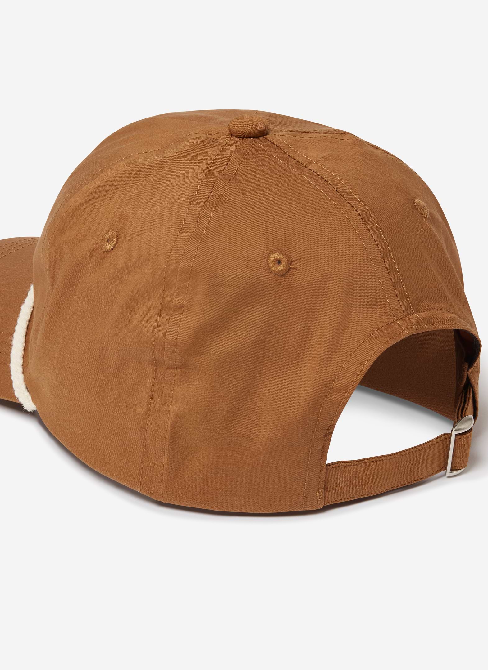 A rear view of the Percival x Brighton & Hove Albion F.C. trucker cap in rust, showing the adjustable strap and metal buckle.