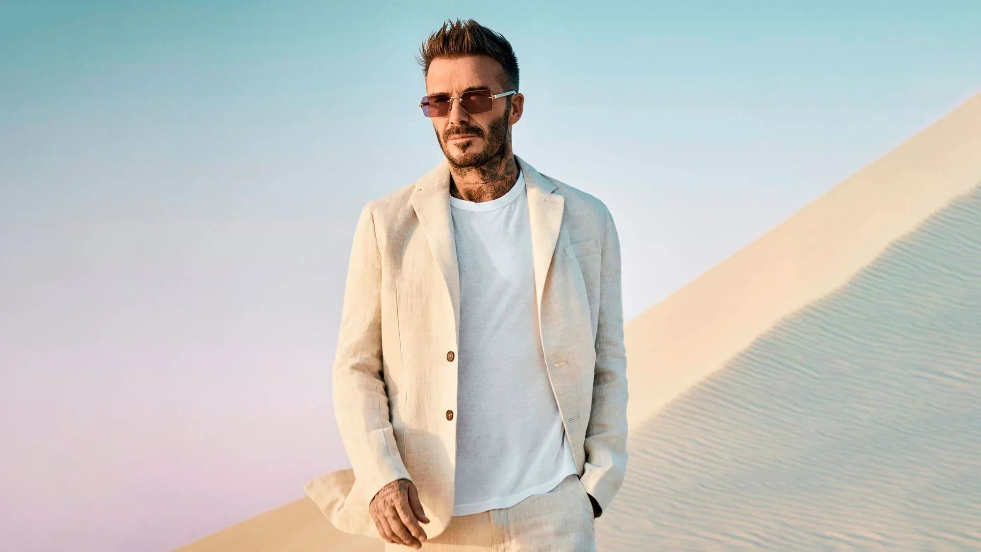 David Beckham wearing a cream linen two-piece suit by Percival Menswear.