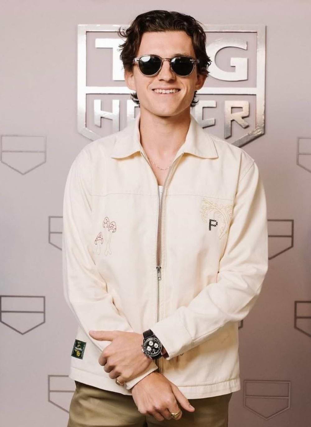 Tom Holland wearing cream jacket by Percival Menswear