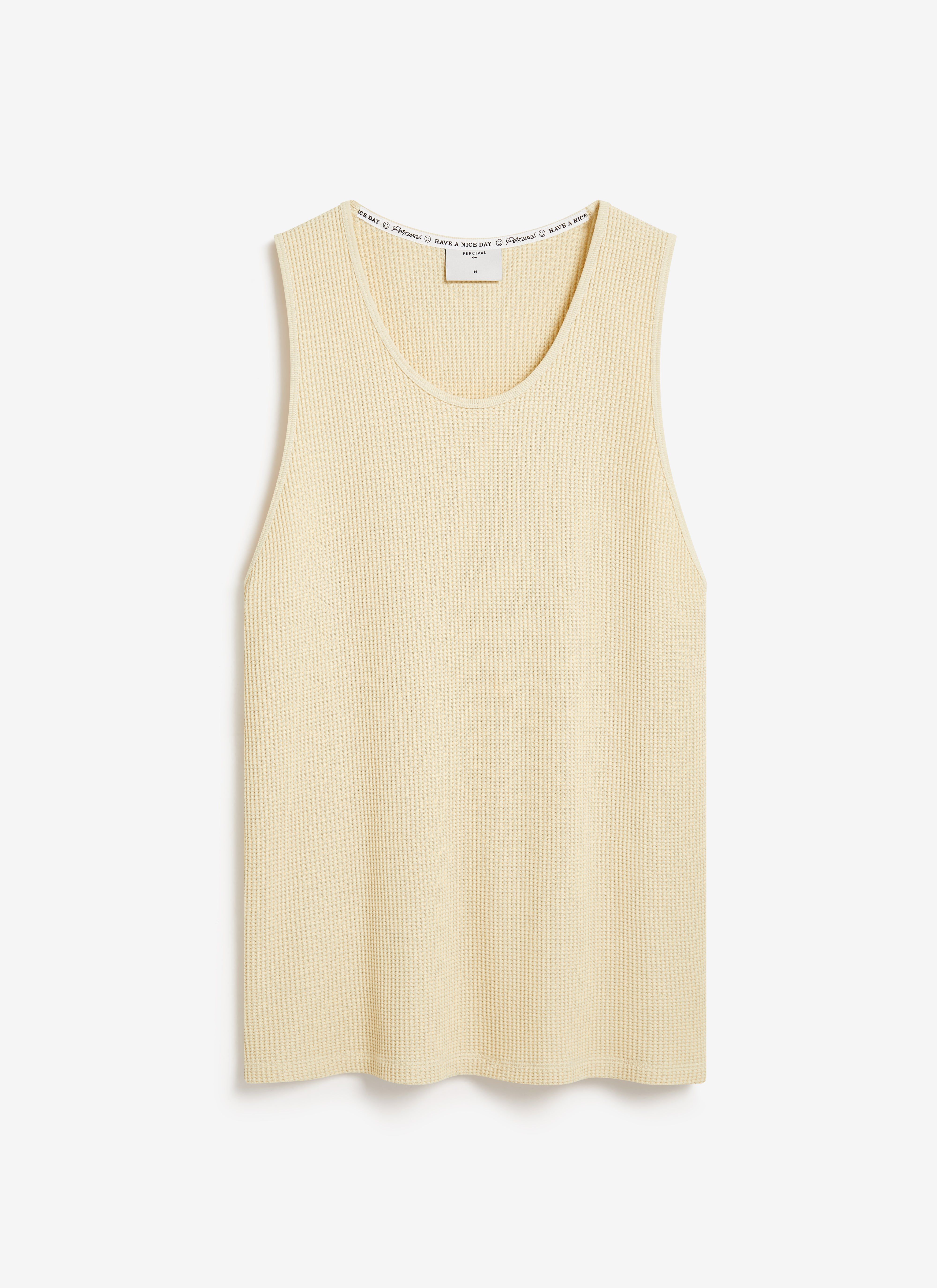 The Percival Cotton Waffle Vest in ecru, laid flat on a plain background to showcase its textured organic cotton material.