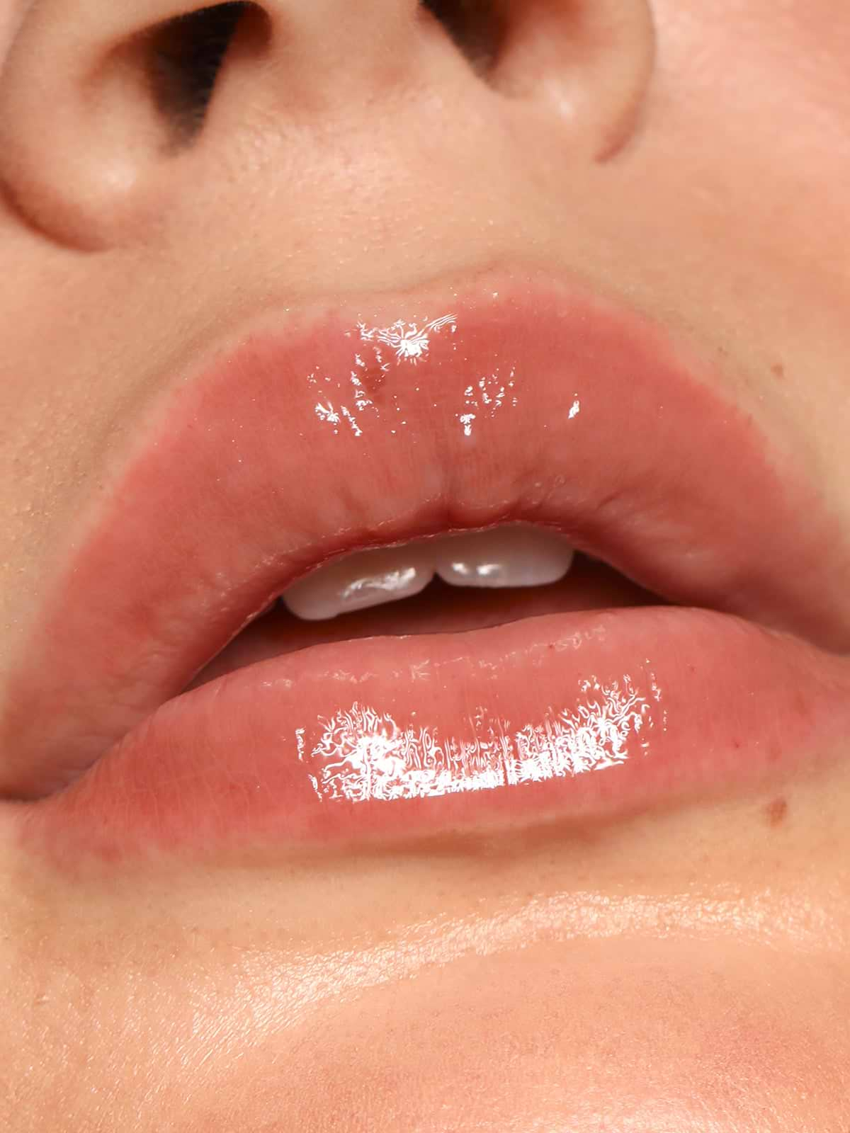 CLOSE UP OF LIPS WEARING REFY LIP GLOSS IN TAUPE