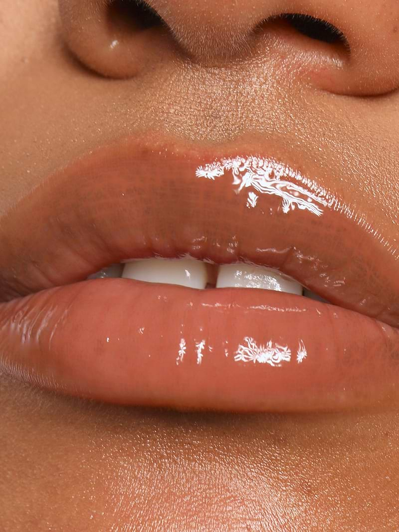 CLOSE UP OF LIPS WEARING REFY LIP GLOSS IN TAUPE